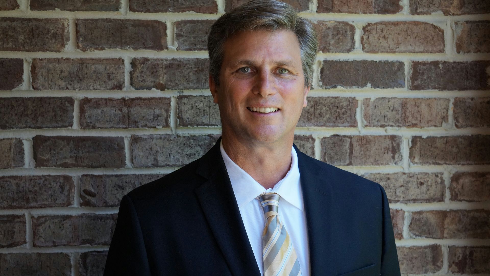 portrait photography of man wearing black suit jacket