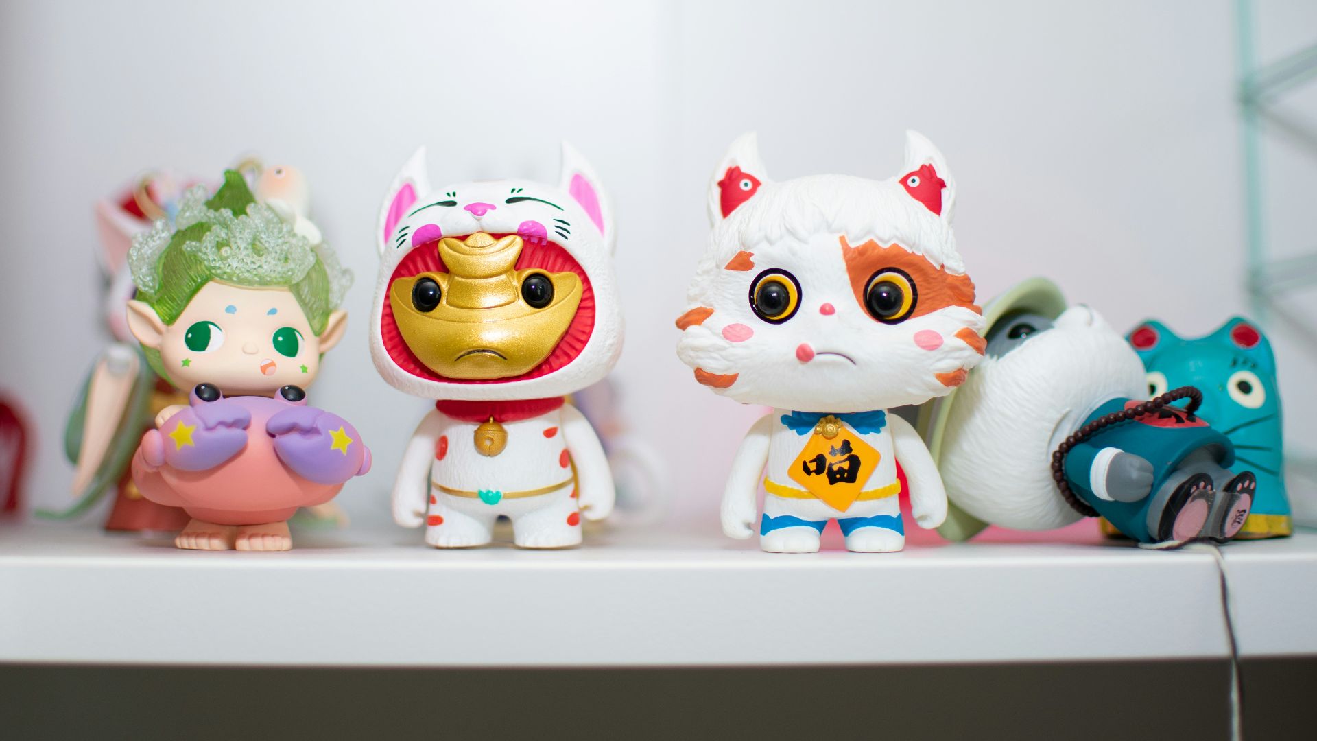 three white and red ceramic owl figurines