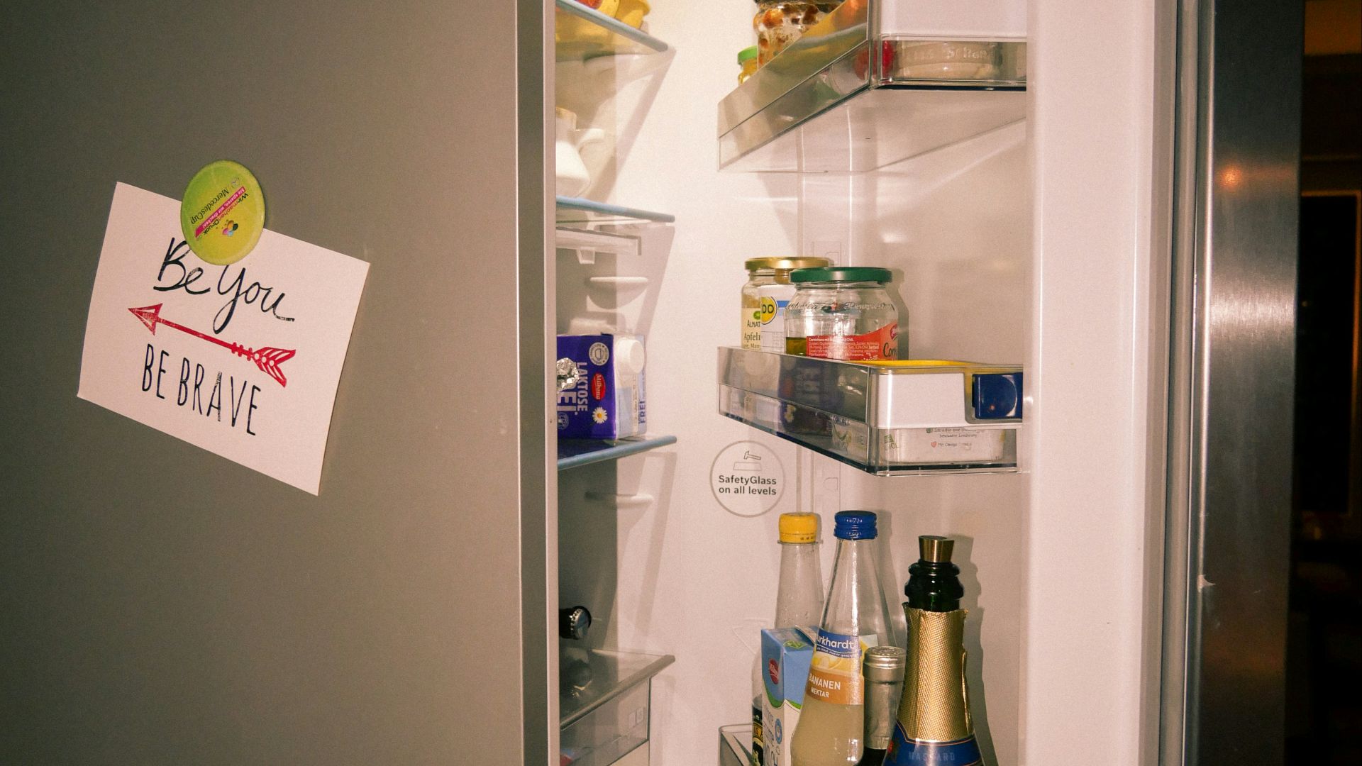 A refrigerator with its door open and food in it