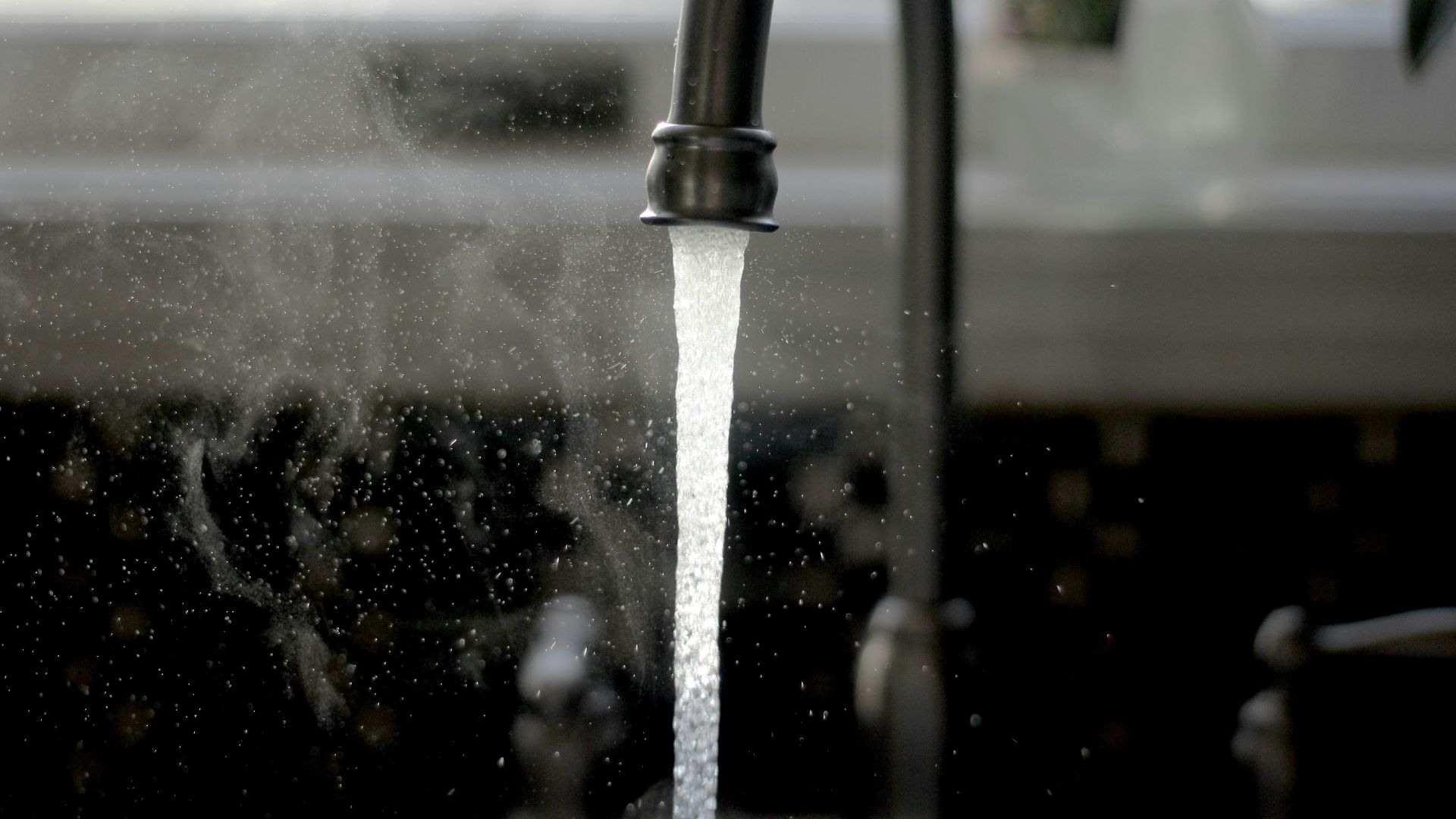 a faucet running water from a kitchen sink