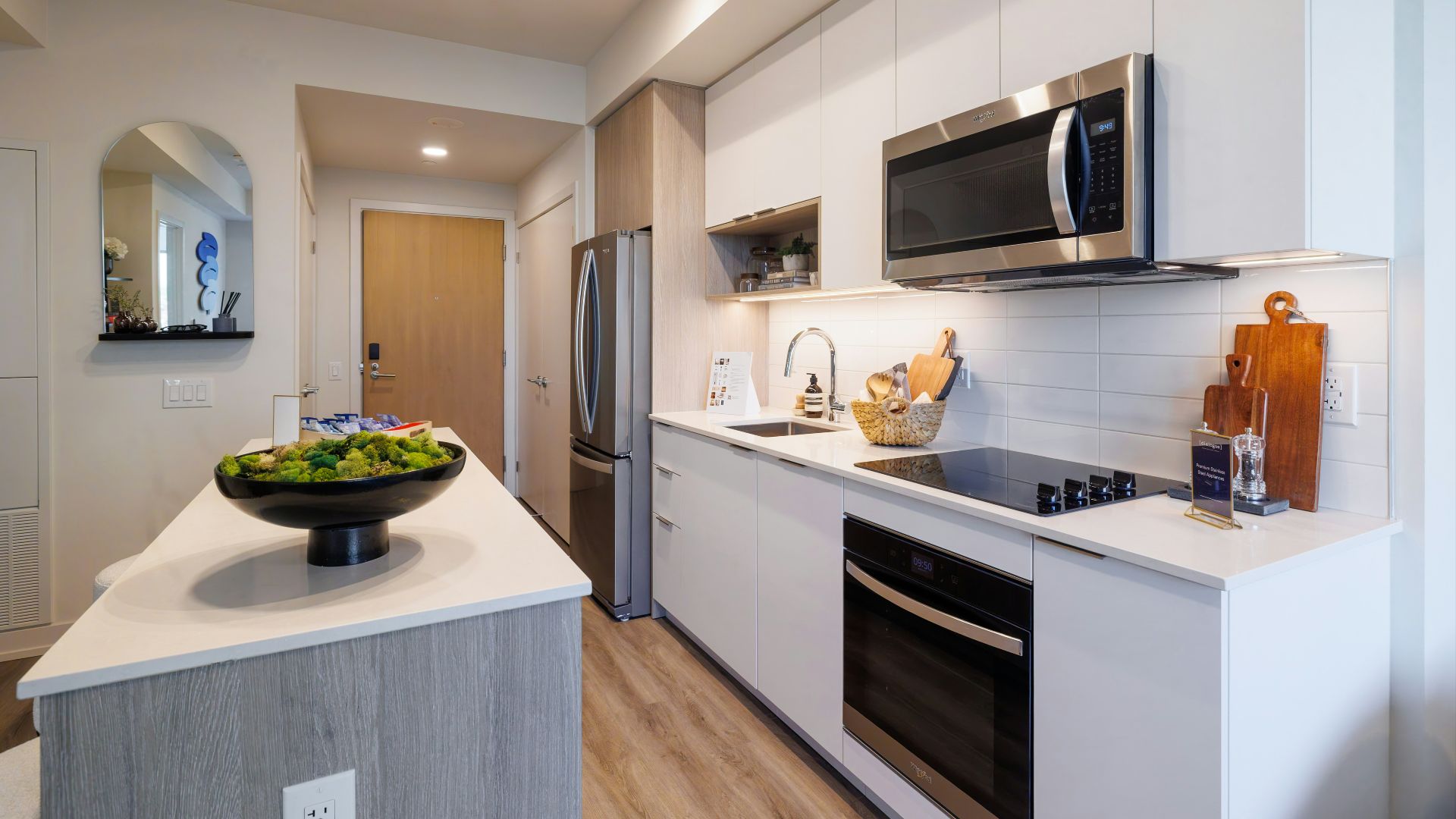 Modern kitchen with stainless steel appliances and island.