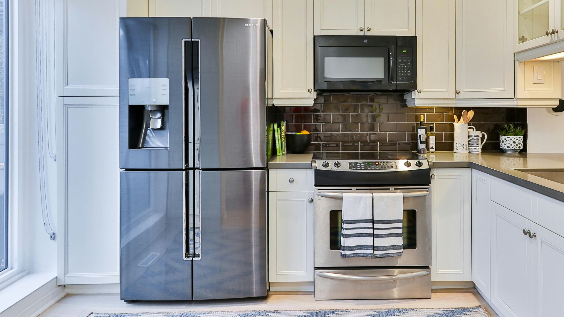 silver french door refrigerator beside white wooden kitchen cabinet