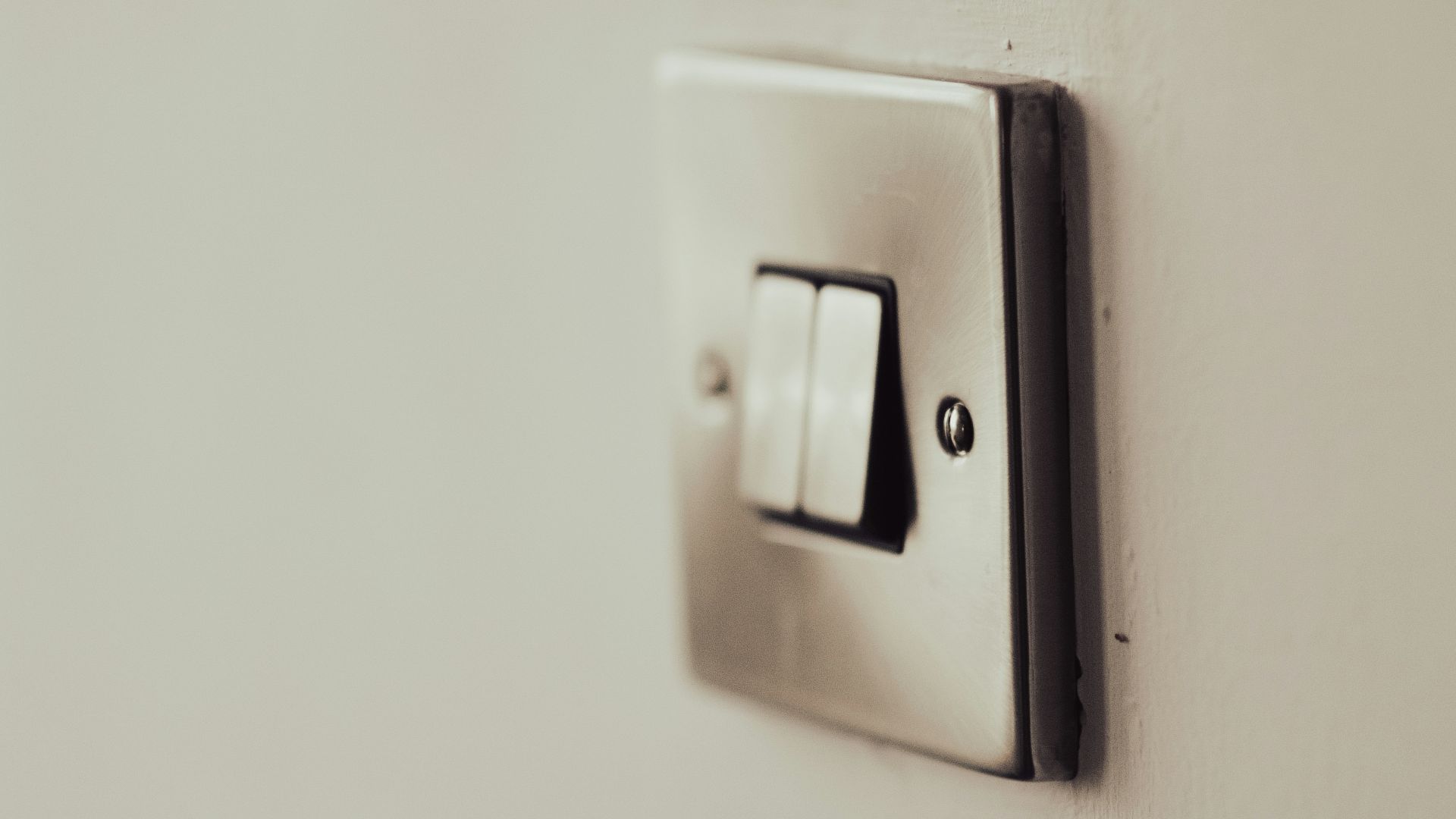 white light switch on white painted wall