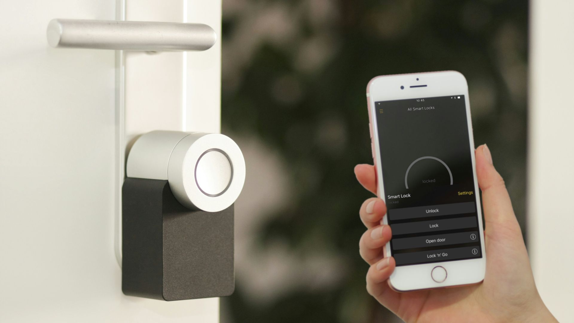 gold Apple iPhone smartphone held at the door