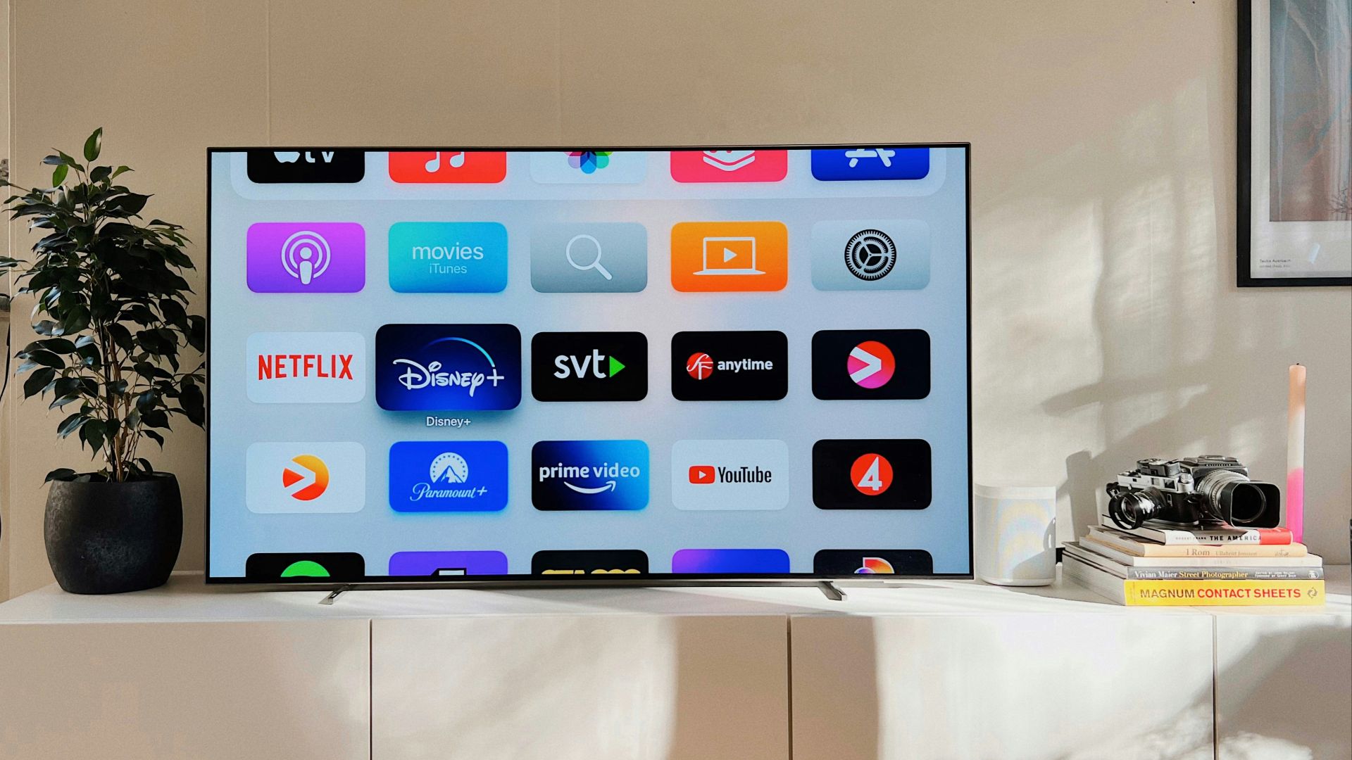 a flat screen tv sitting on top of a white cabinet