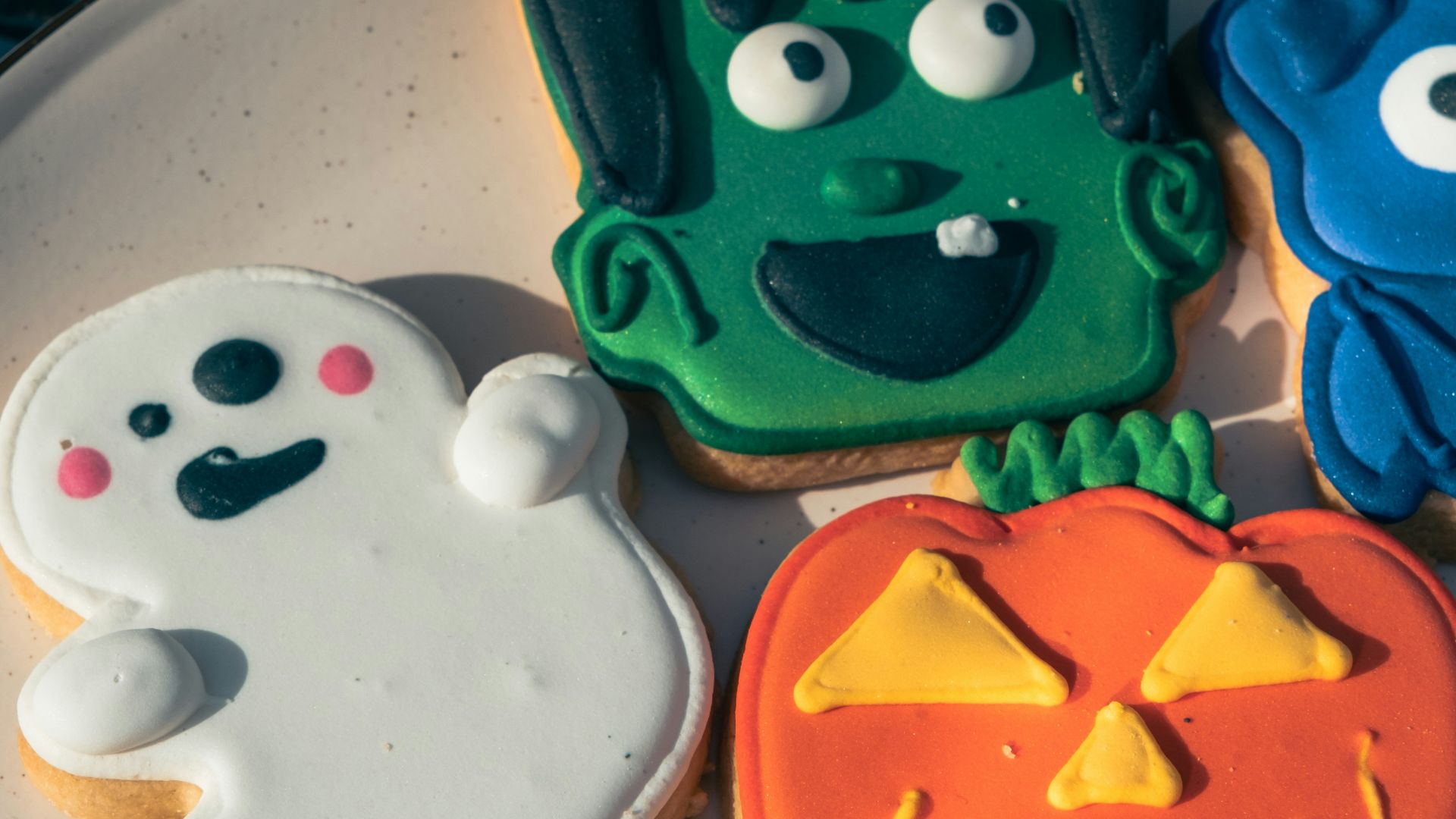 a white plate topped with cookies covered in frosting