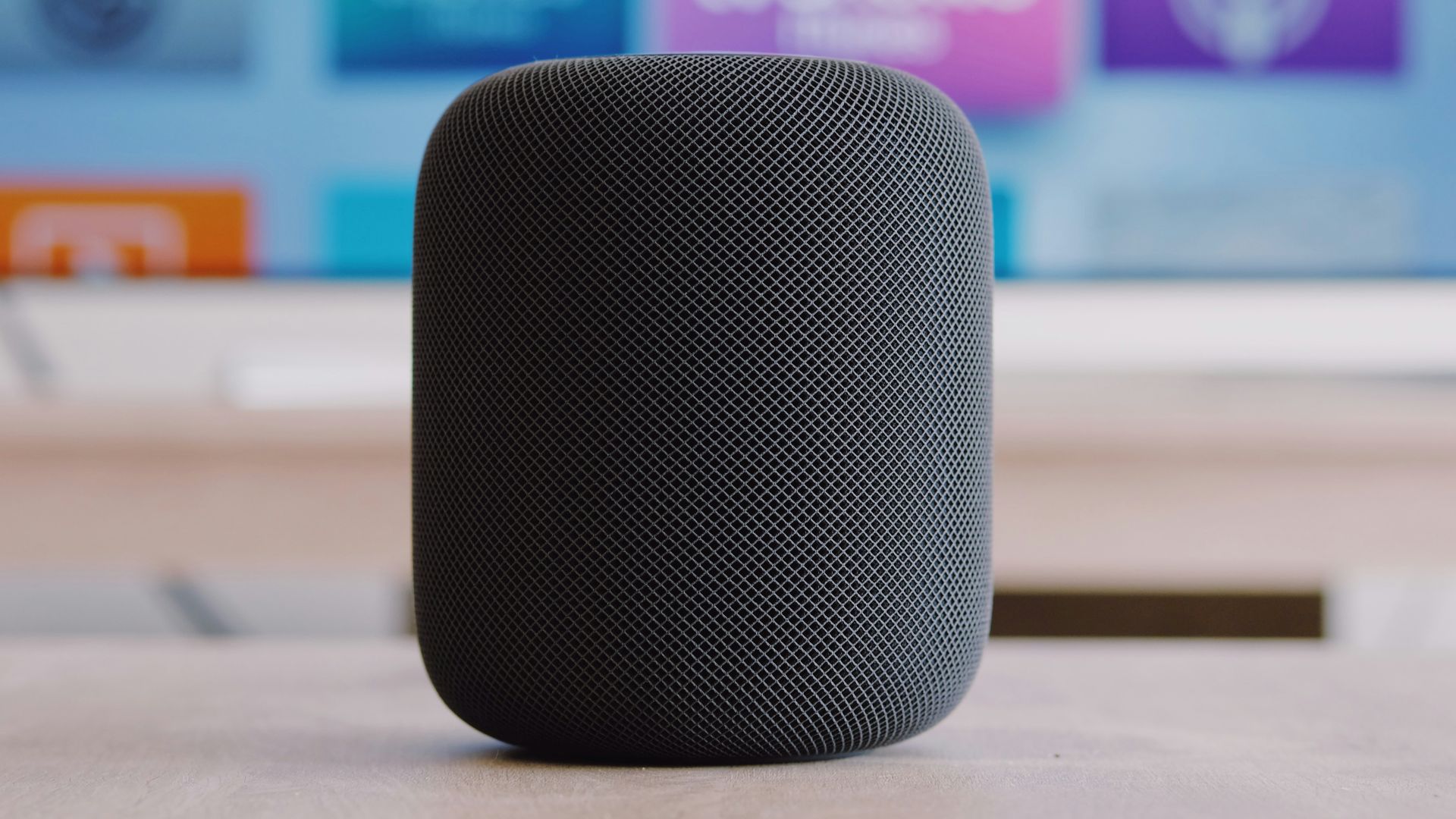 black Apple HomePod speaker on table