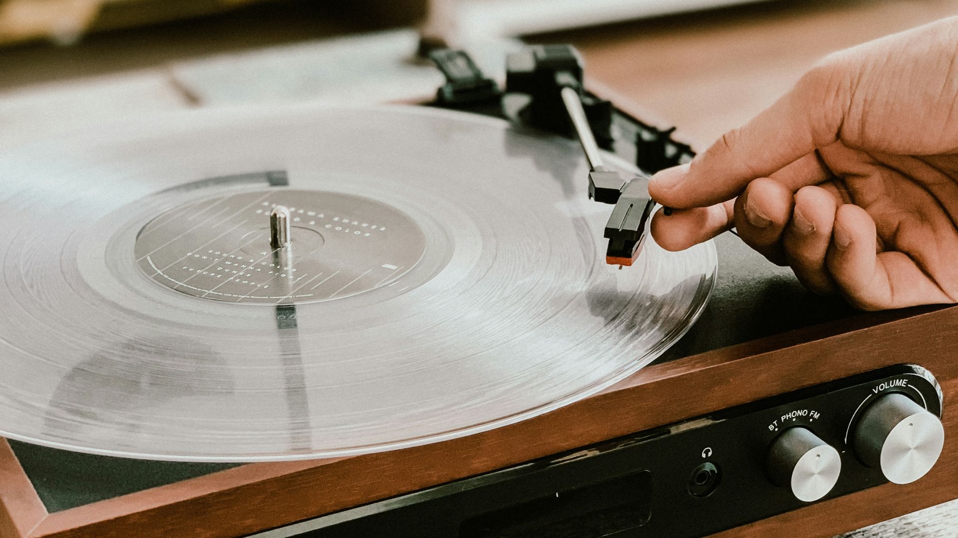 person playing record on Victrola turntable