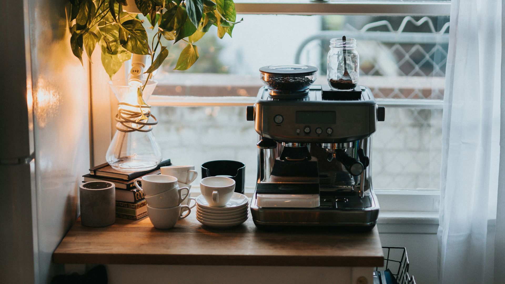 black and silver coffee maker on brown wooden table