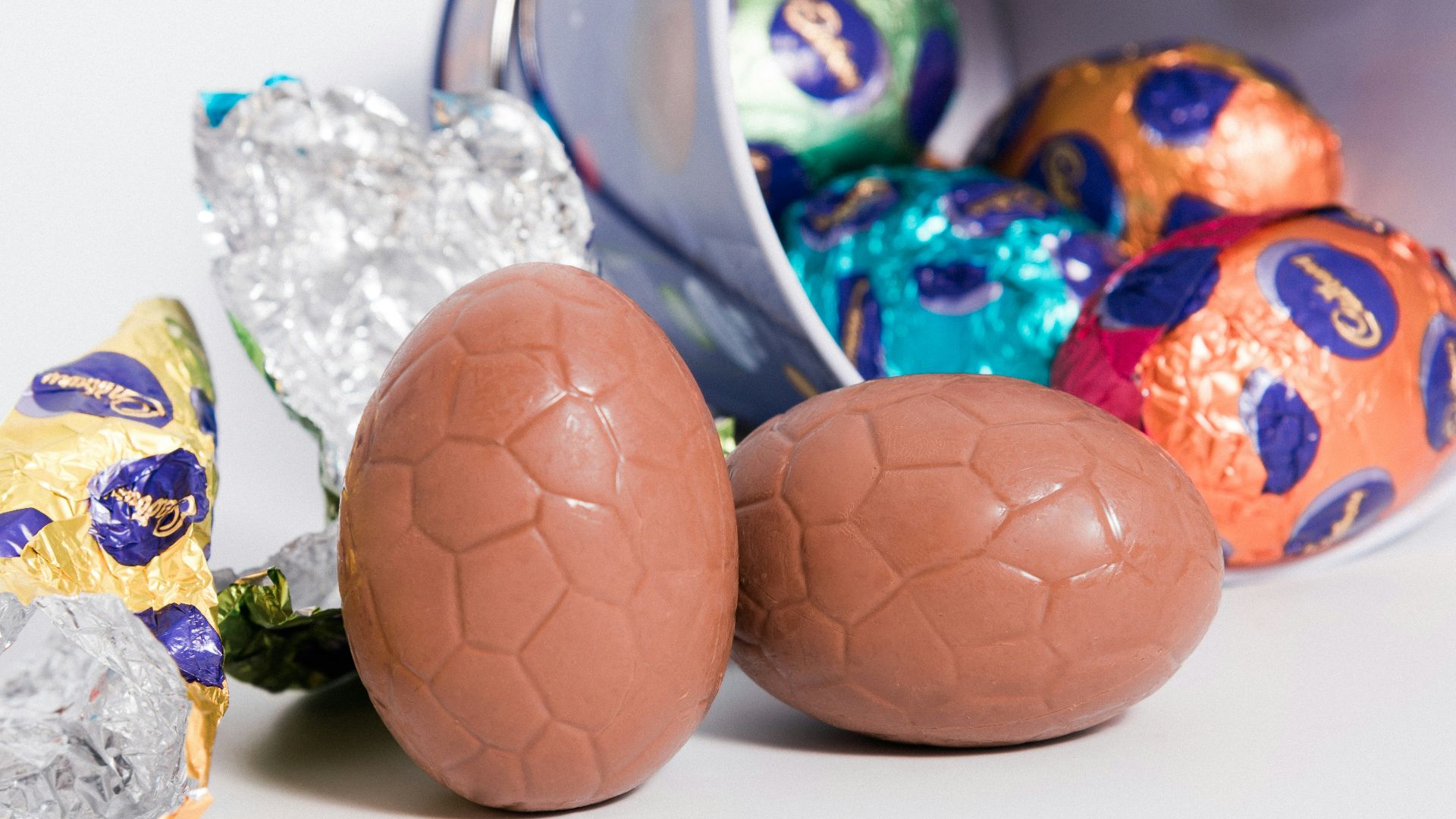 a bucket filled with chocolate eggs next to other chocolate eggs
