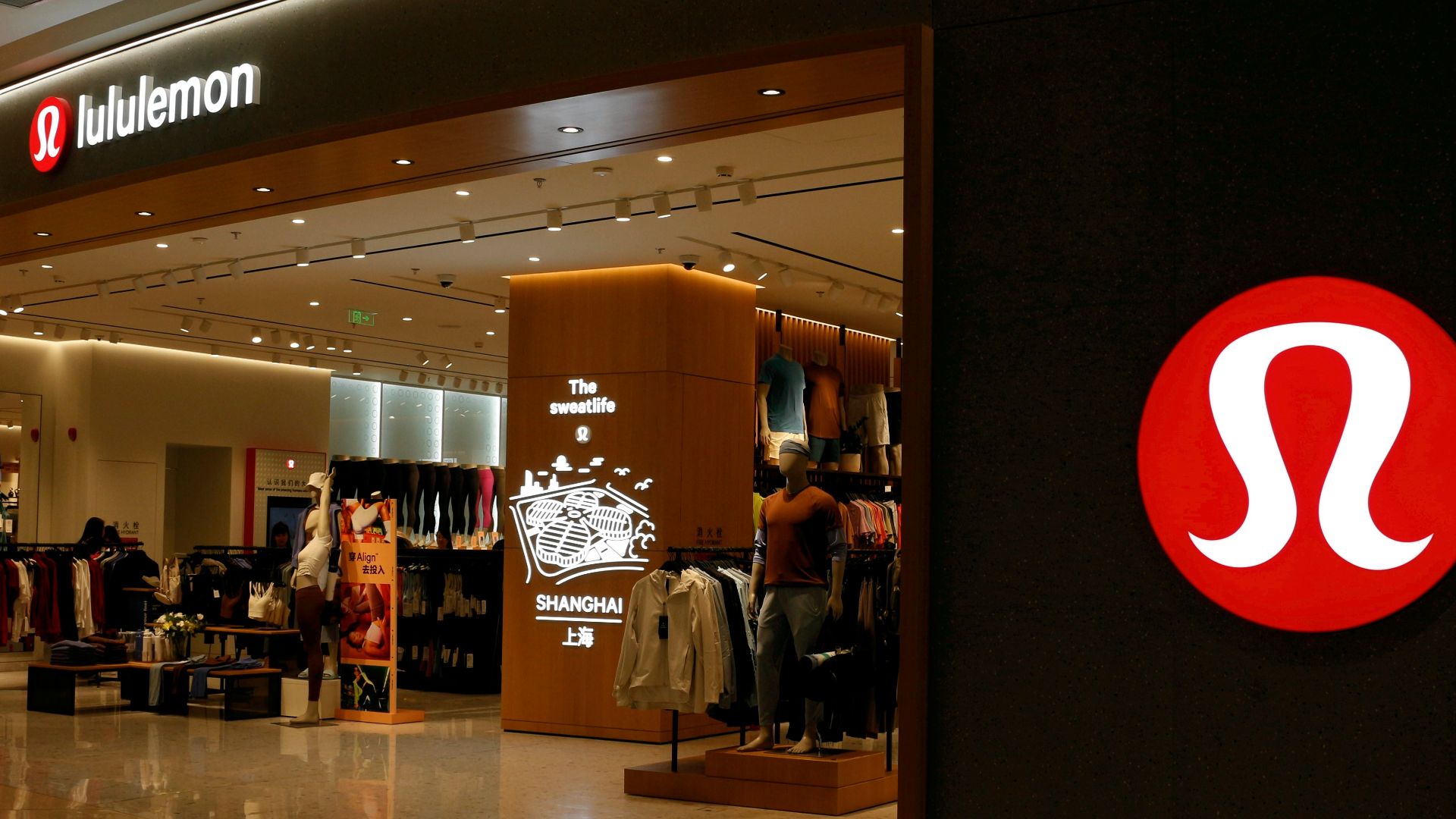 a shopping mall with a sign that says the store is open