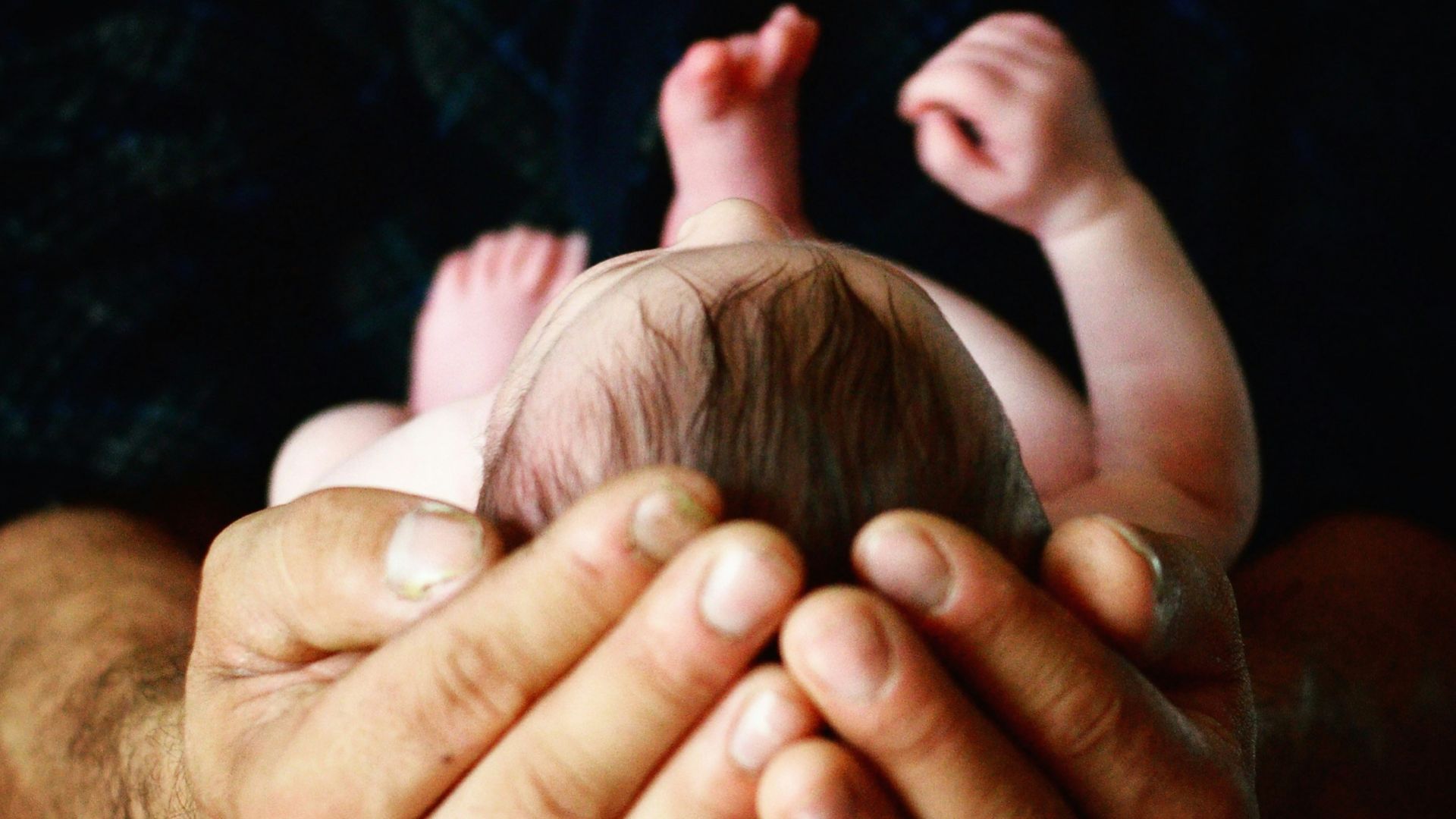 person holding babys hand