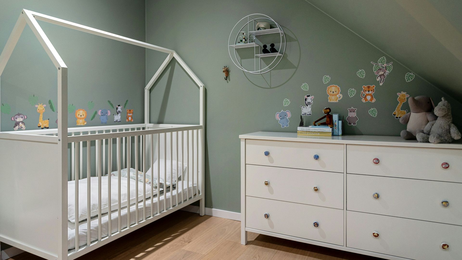 A baby's room with a crib and dresser