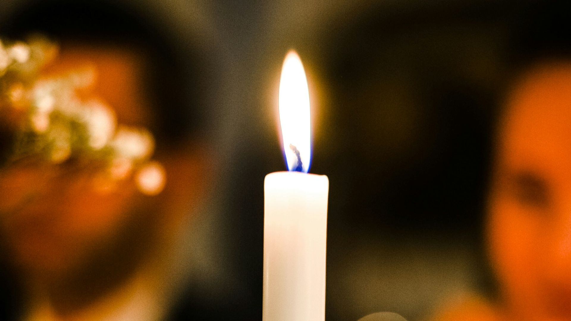 a white candle sitting on top of a table