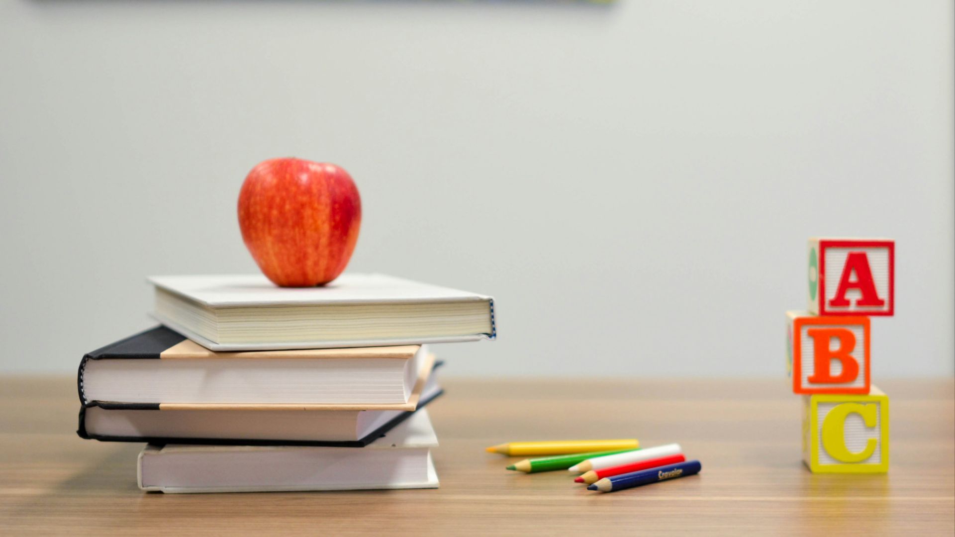 red apple fruit on four pyle books