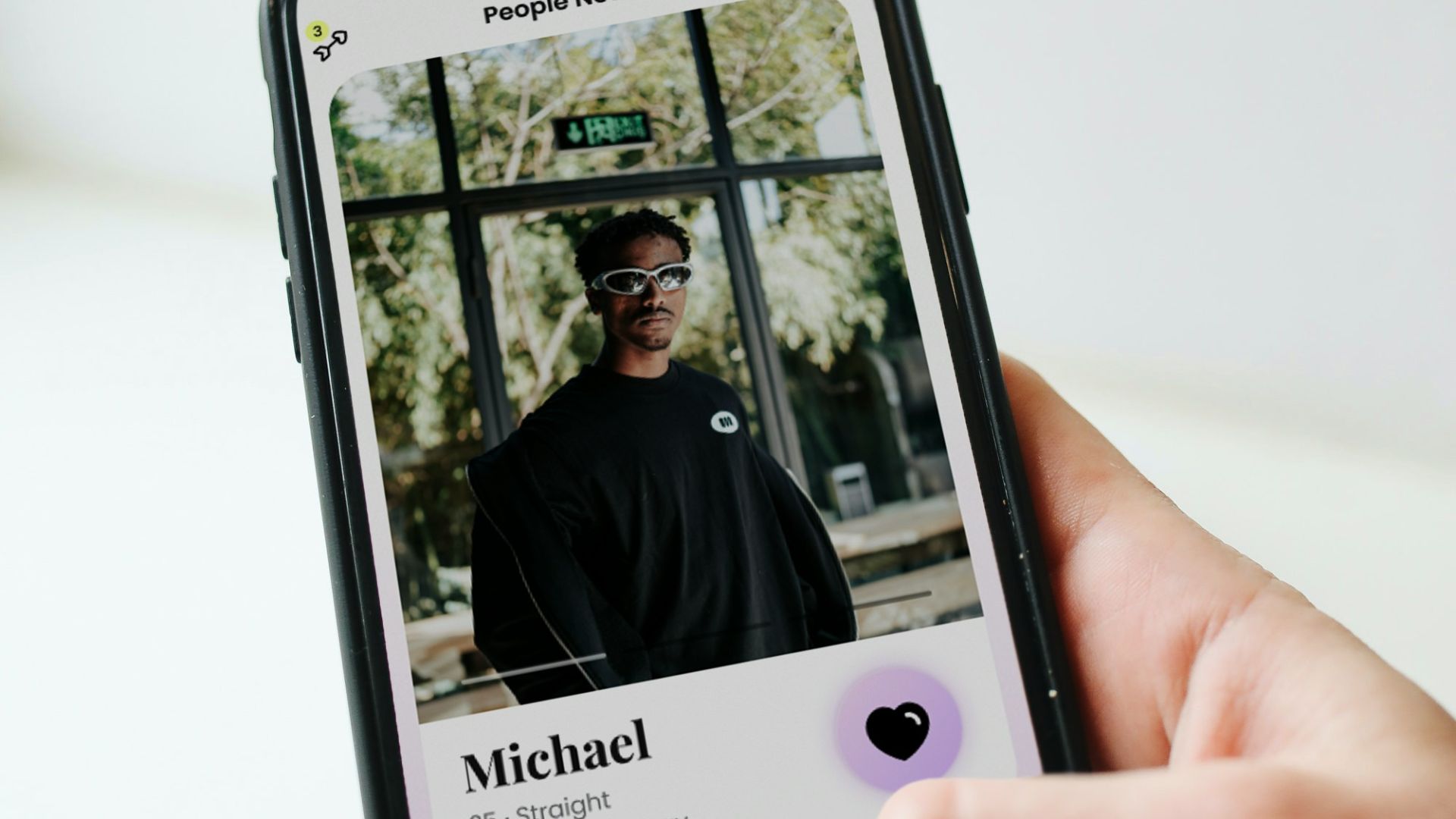 a person holding a cell phone with a picture of a man on it