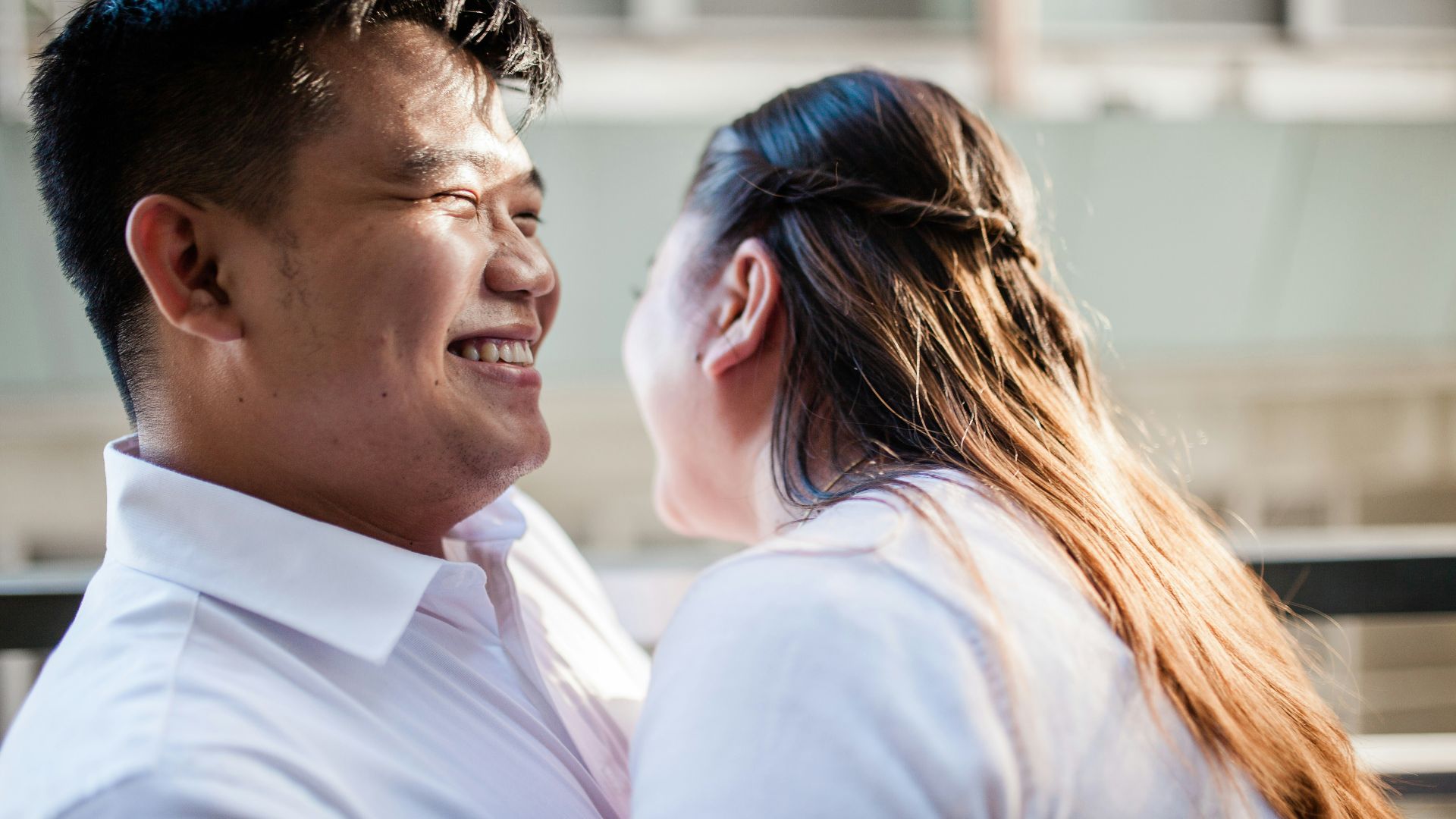 man in white polo shirt kissing woman in white shirt