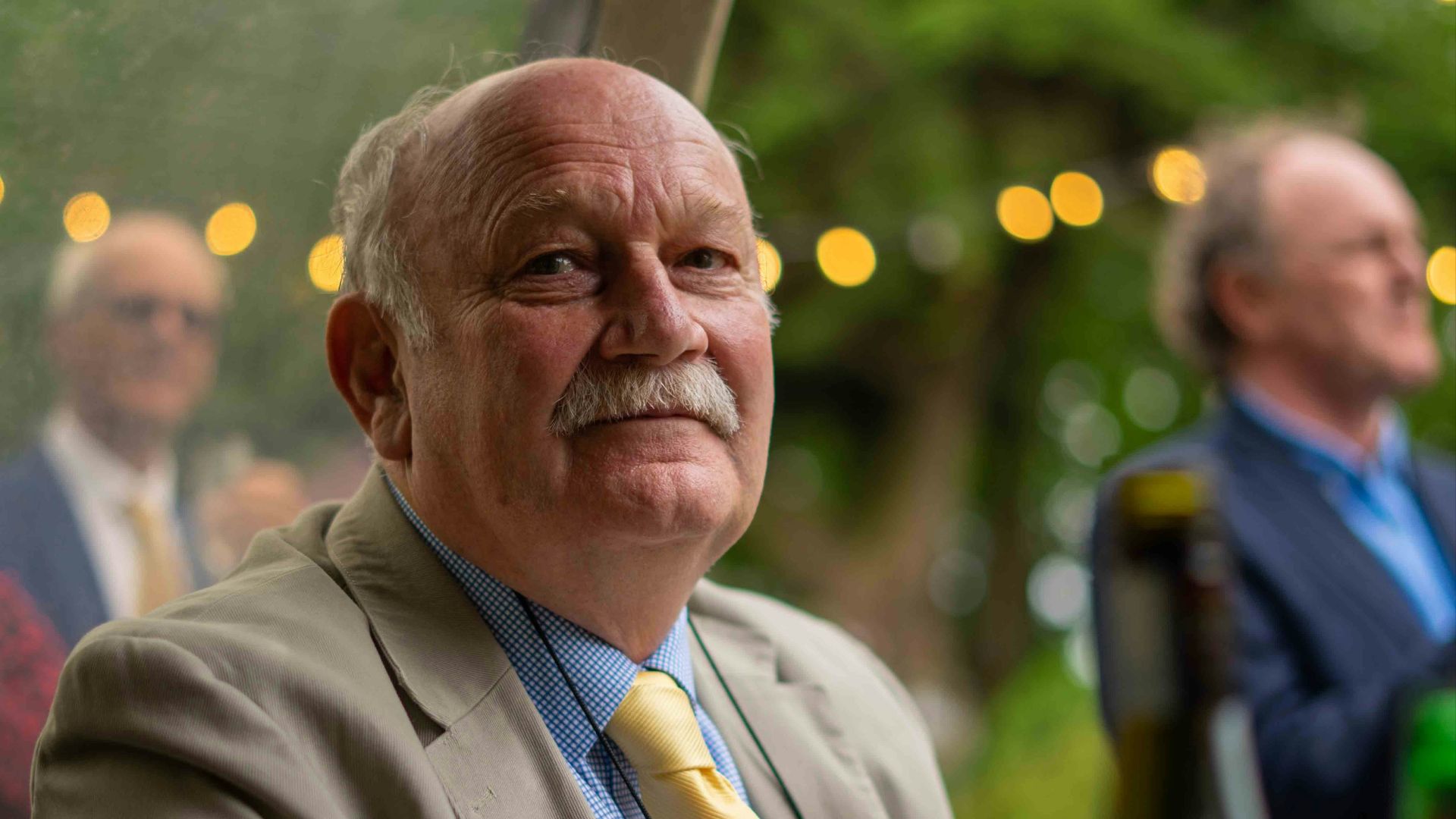 man in gray suit jacket sitting on chair