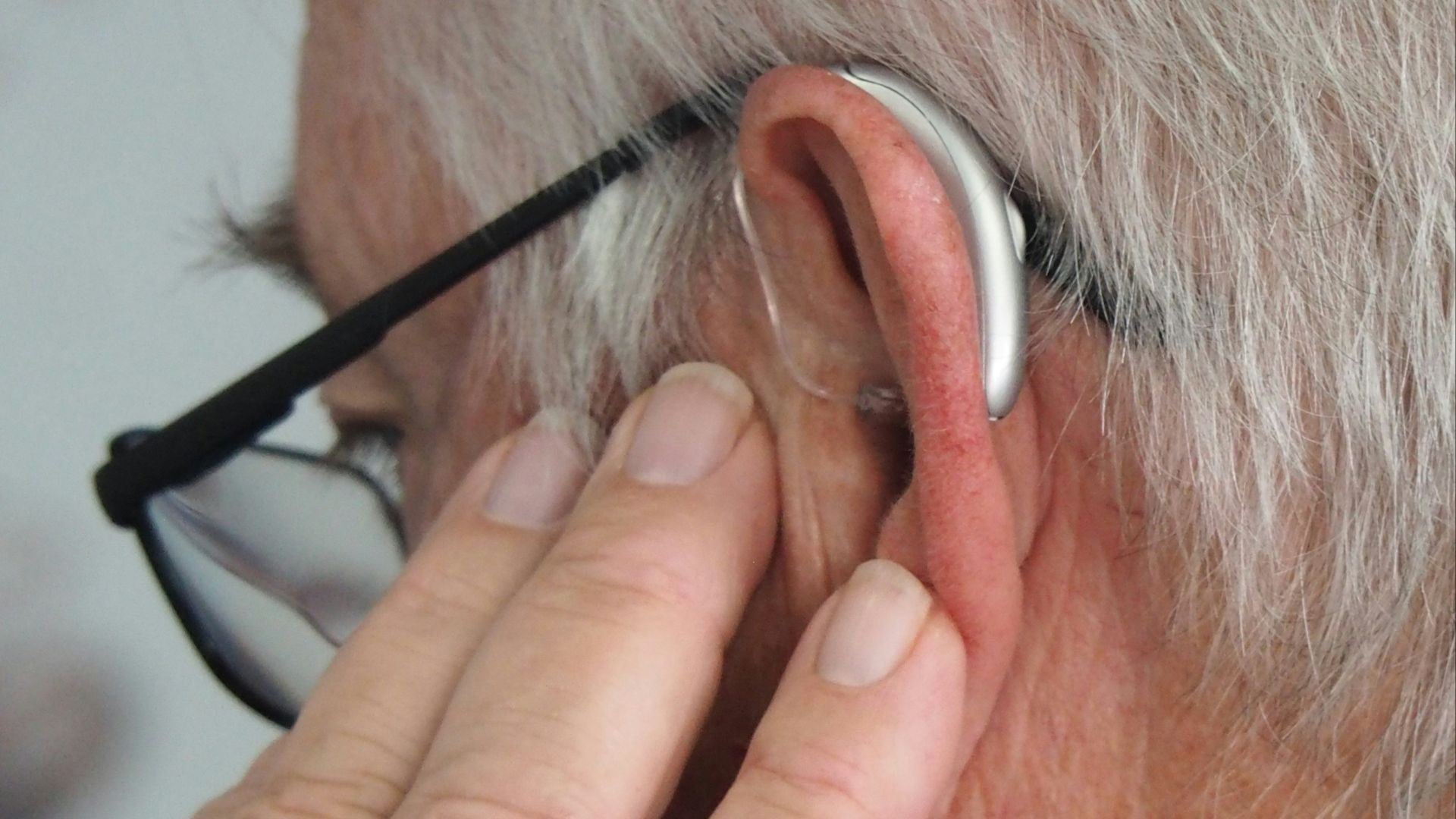 a man wearing glasses and a pair of ear phones