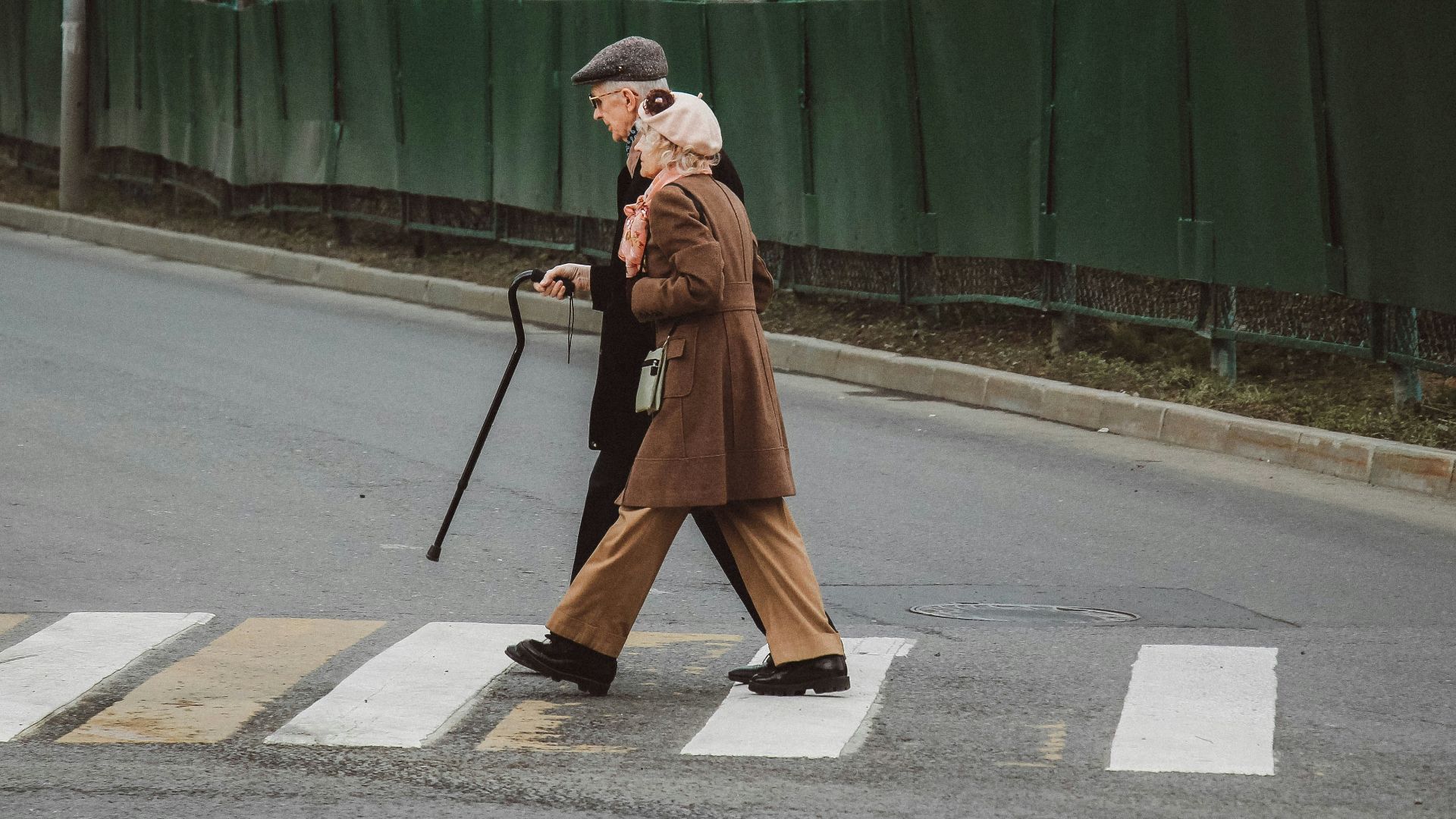 man and woman walking on pedestrian line during daytime