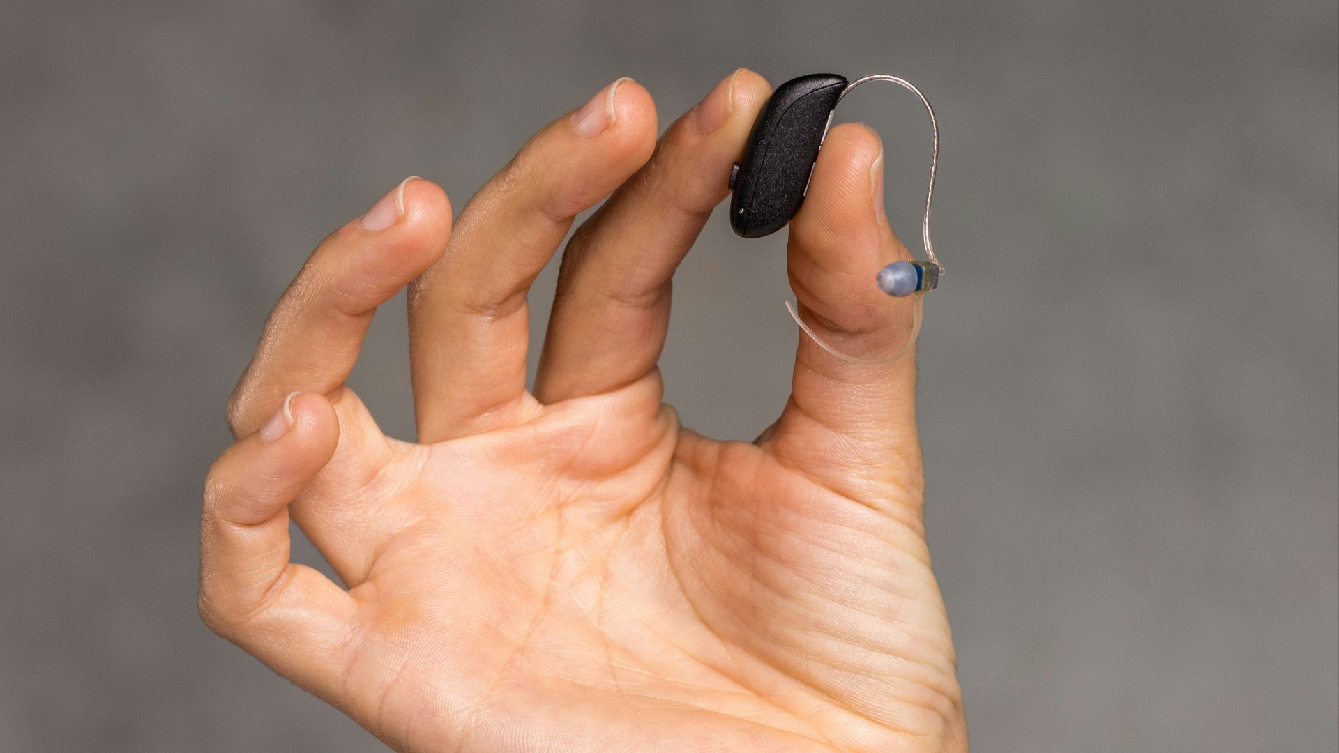 a hand holding an object in the air