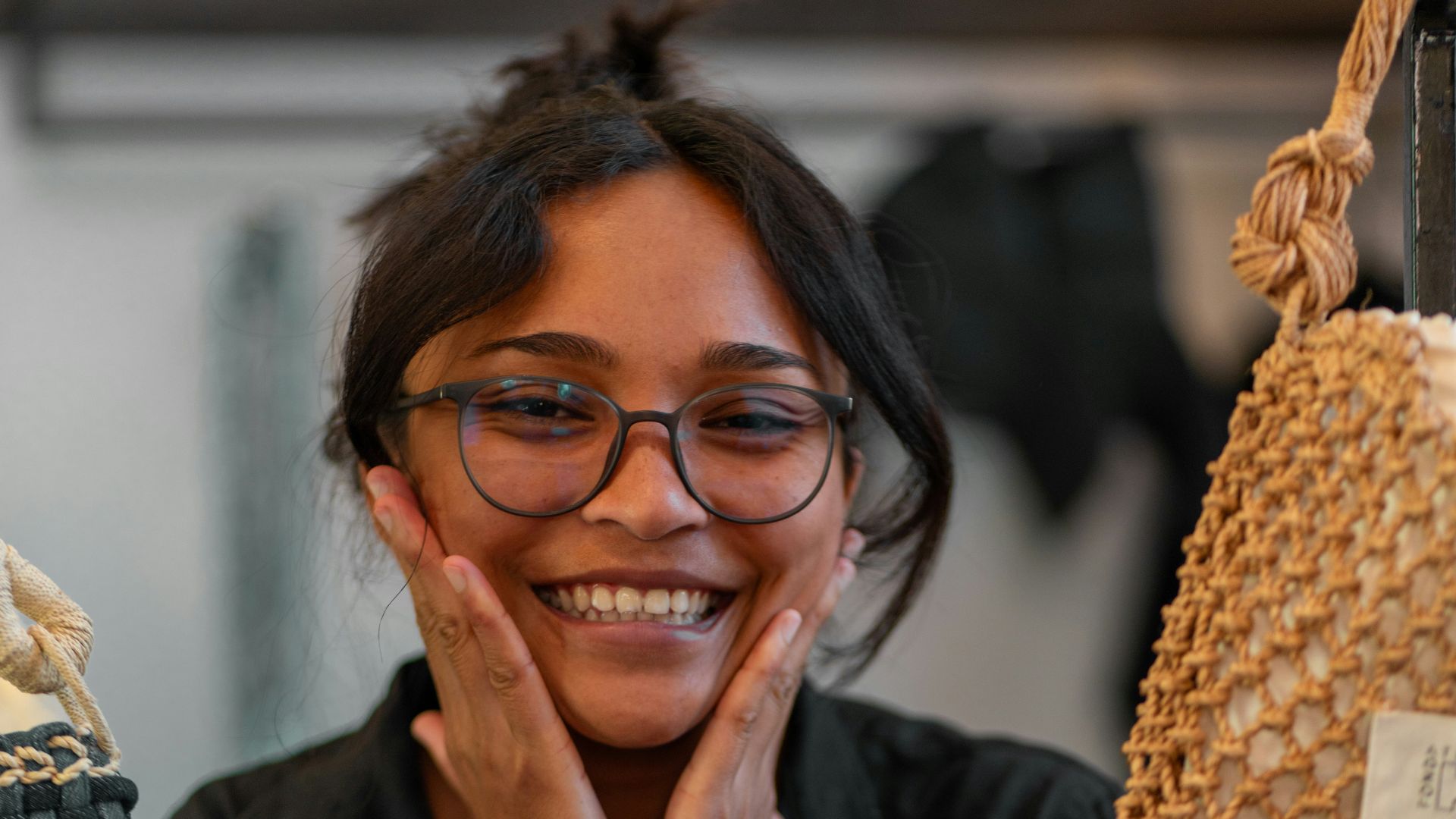 Smiling woman with hands on her cheeks