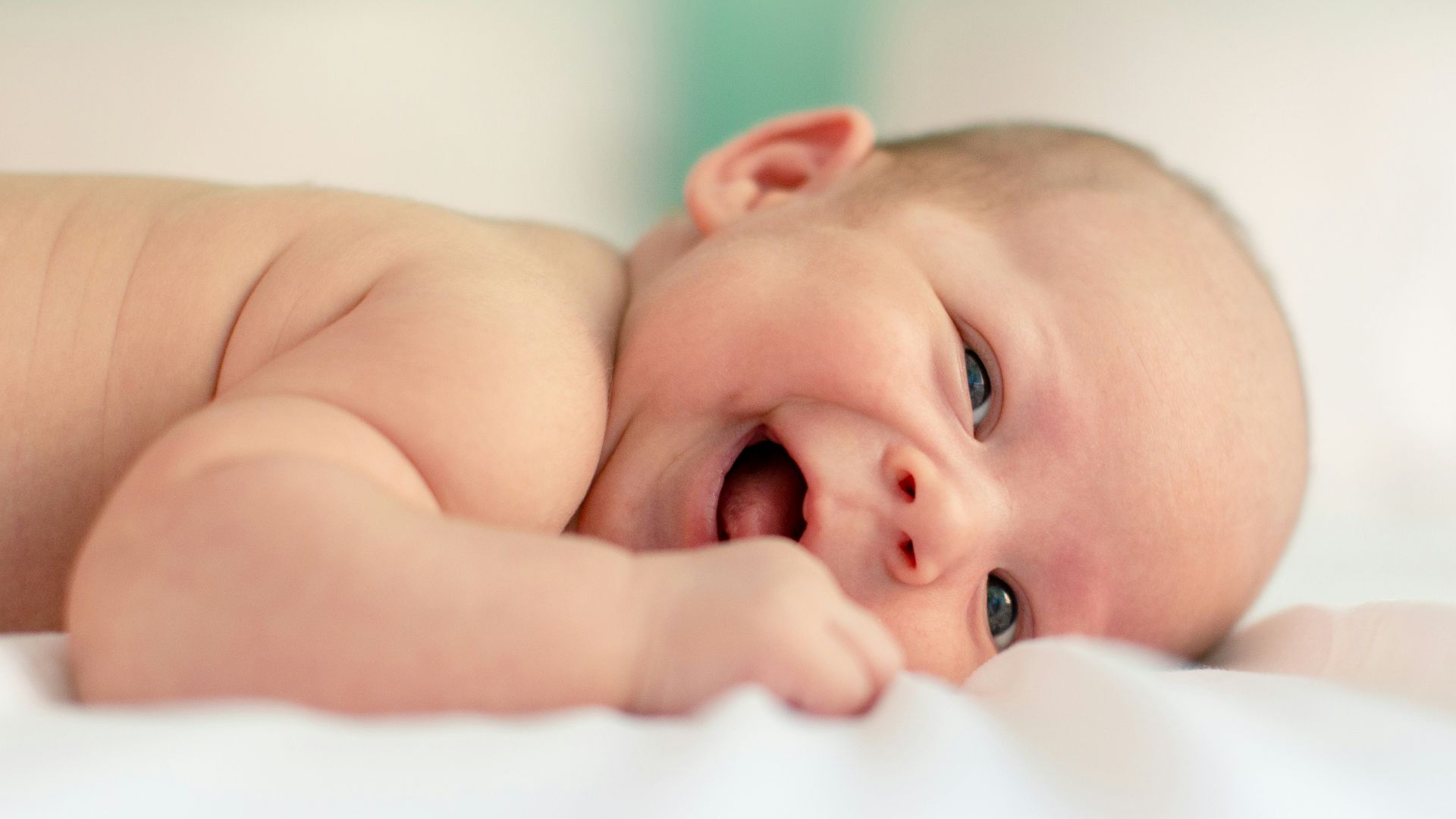 baby lying on fabric cloth