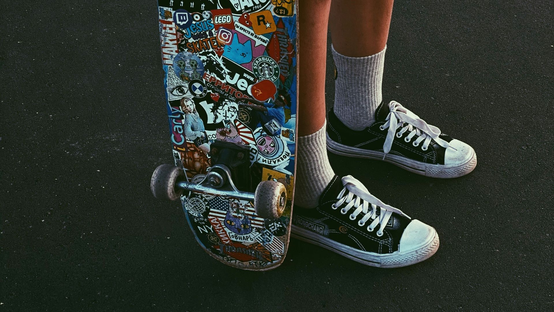 person in blue denim shorts and black and white nike sneakers riding skateboard