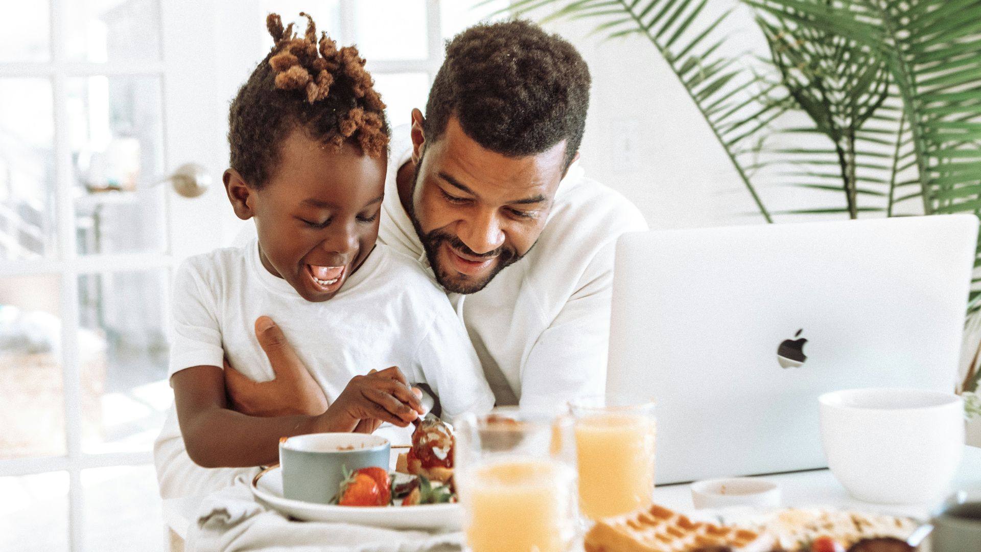 man and woman sitting on white couch