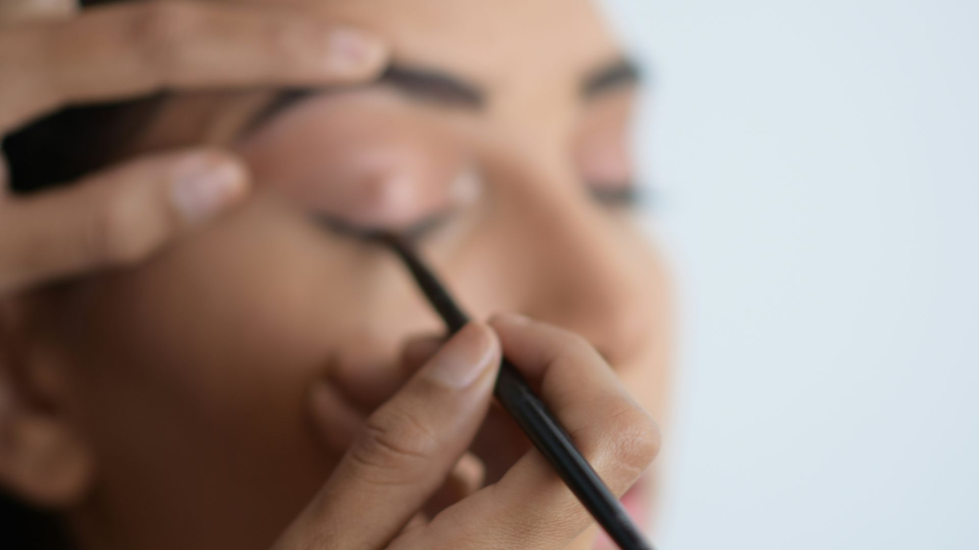 person holding black pen in close up photography