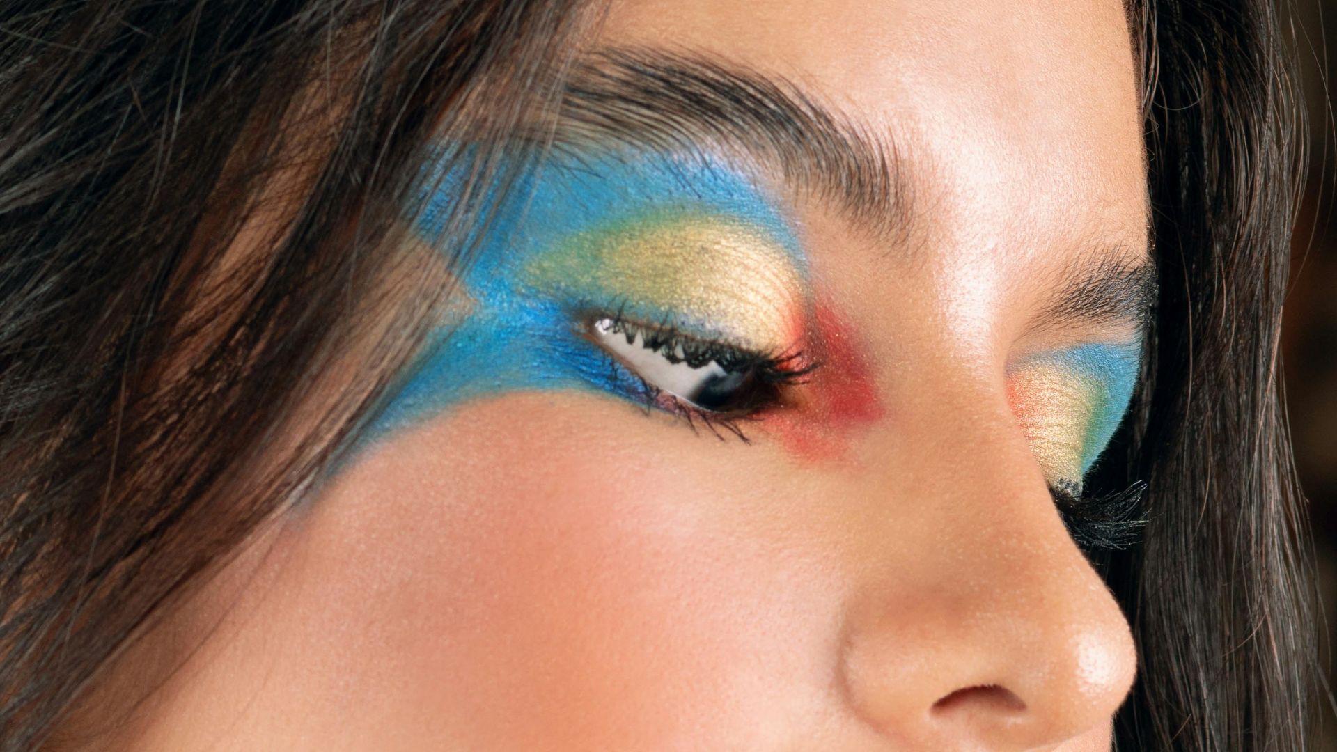 Woman with colorful face paint and makeup.