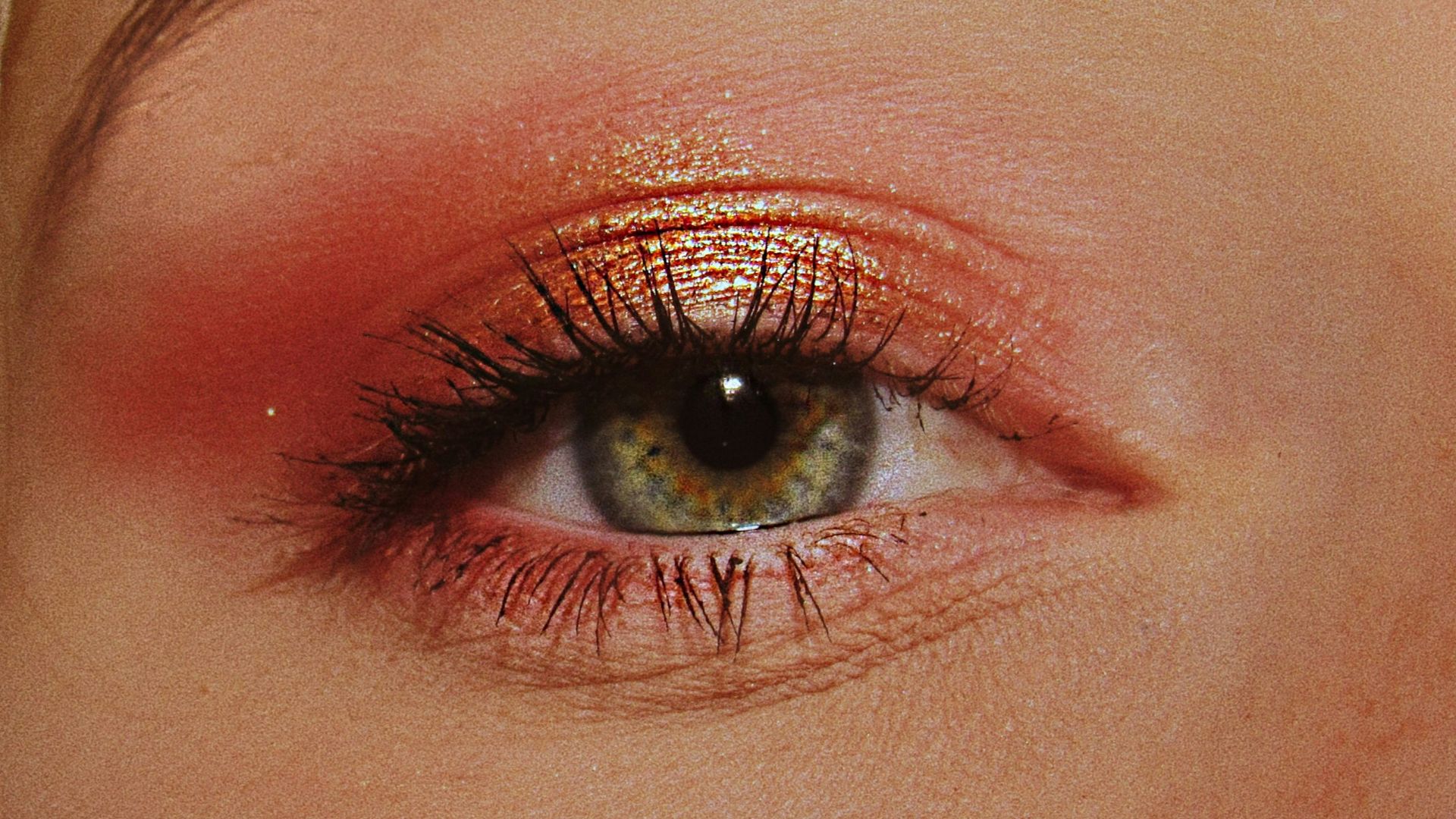 woman with pink and gold eyeshadow makeup