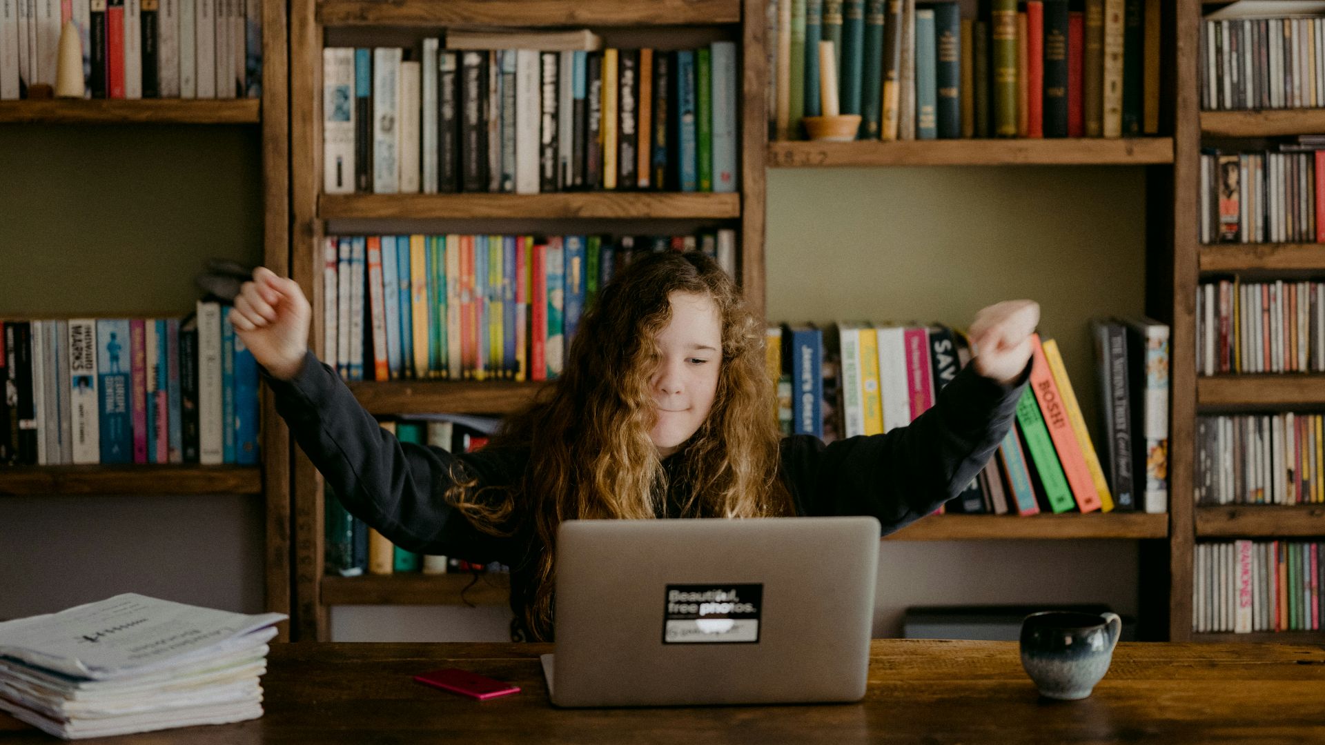 woman in black long sleeve shirt sitting in front of silver macbook