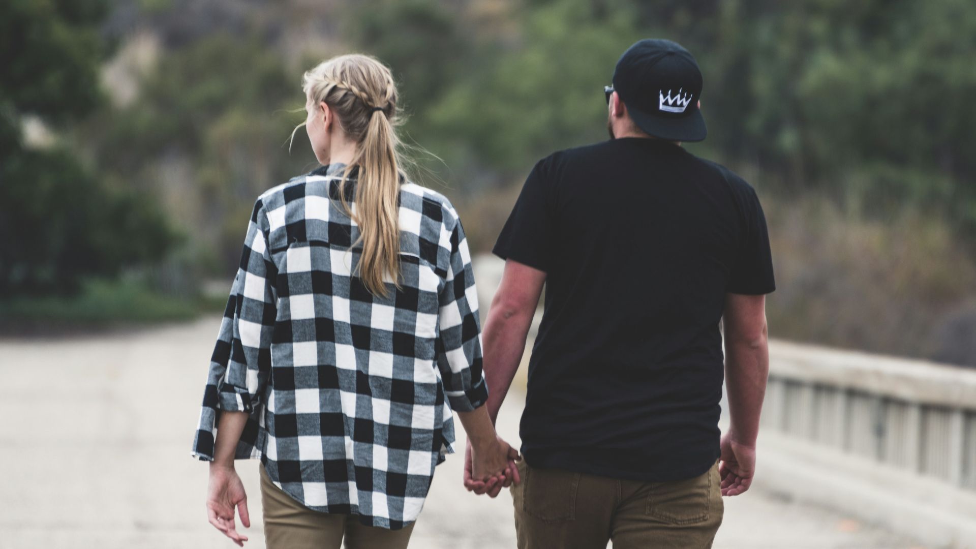man and woman walking on road during daytime