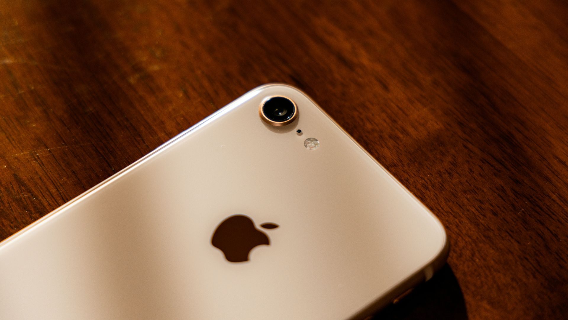 a close up of an iphone on a wooden table