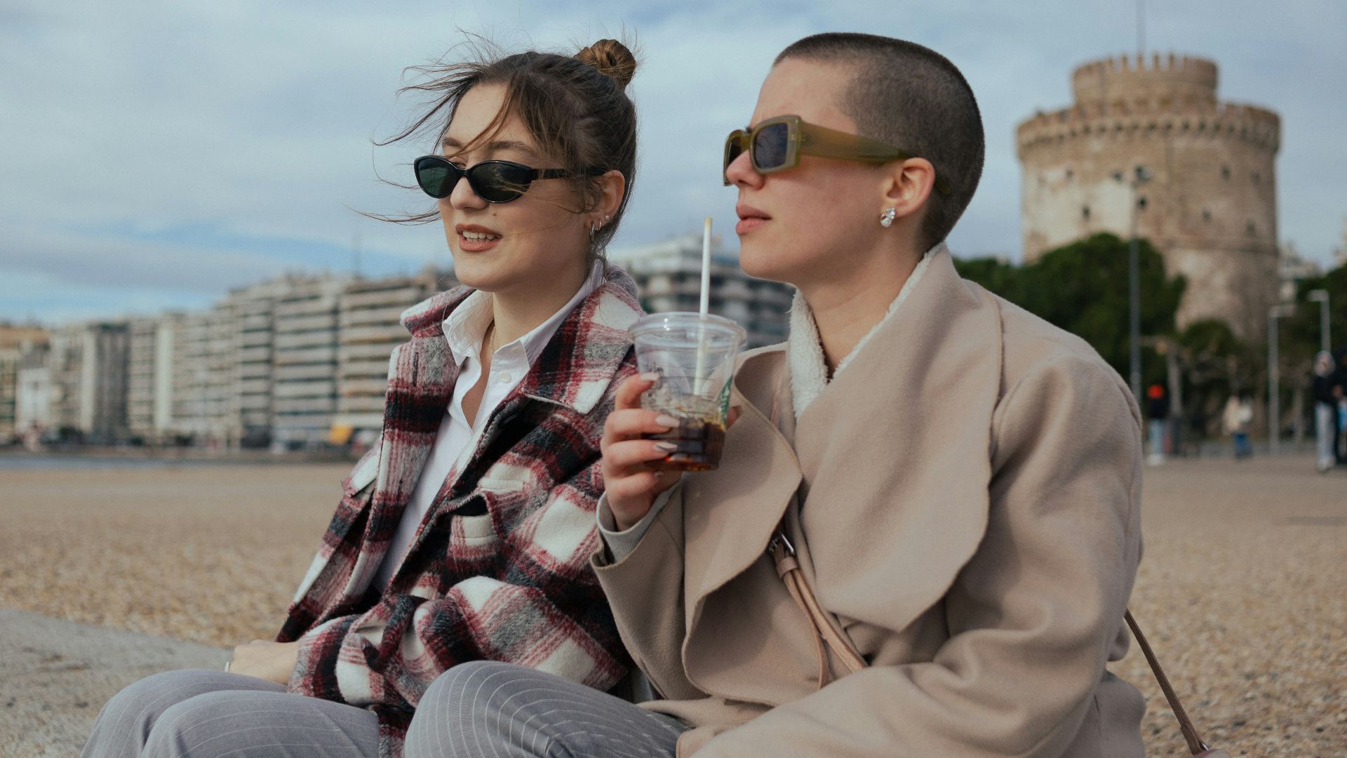 a man and a woman sitting on a beach