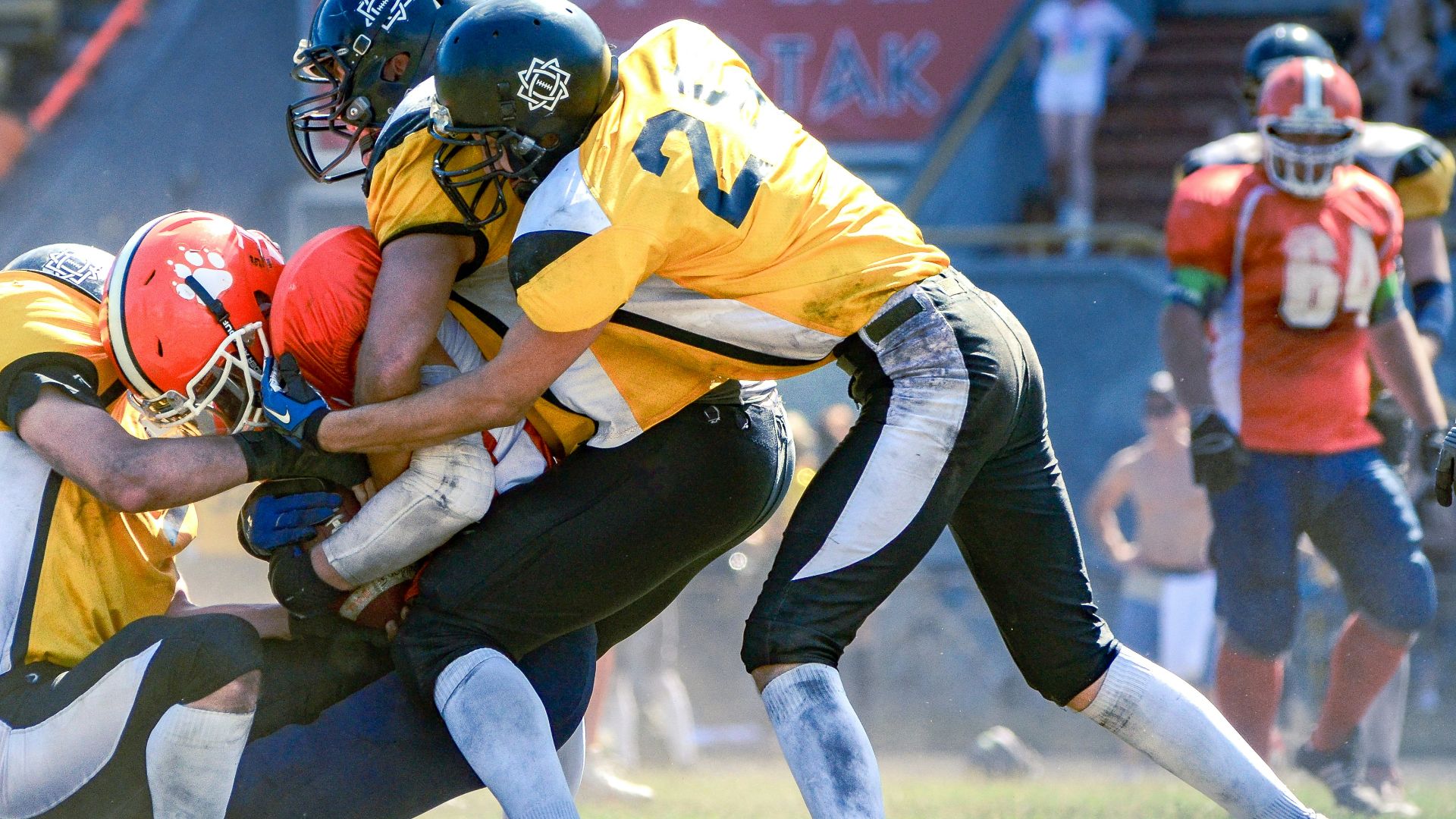 a group of football players playing a game of football