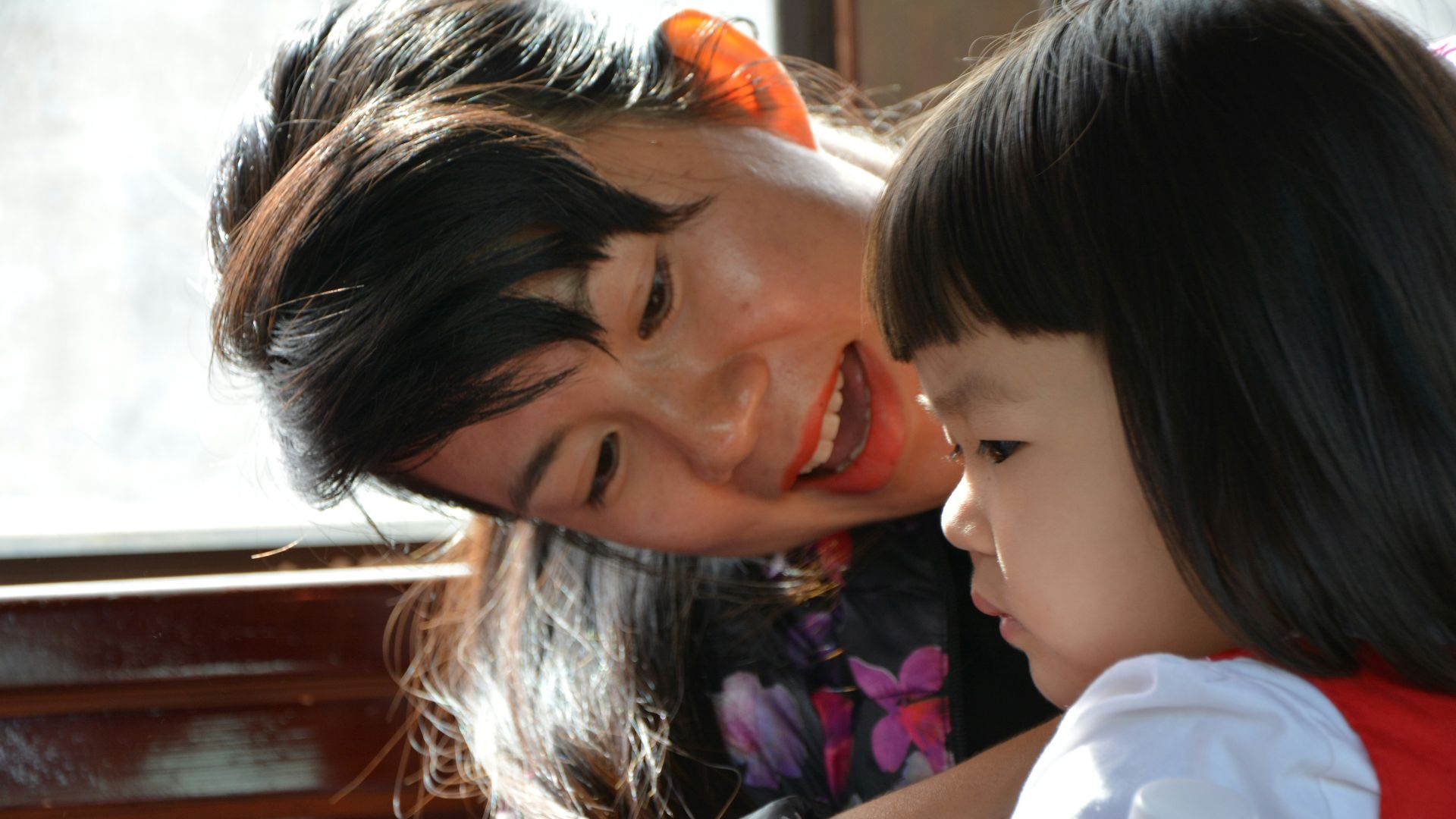 girl in white shirt covering her face
