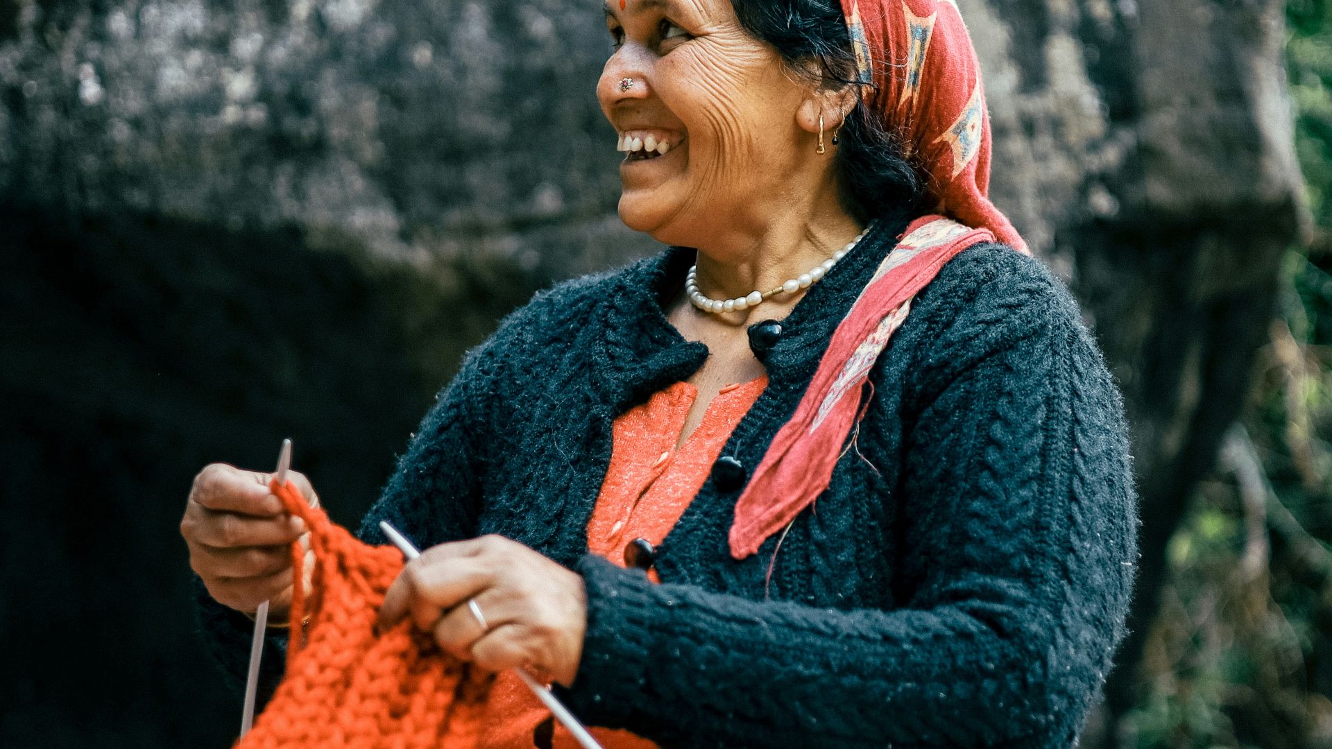 a person holding a red bag