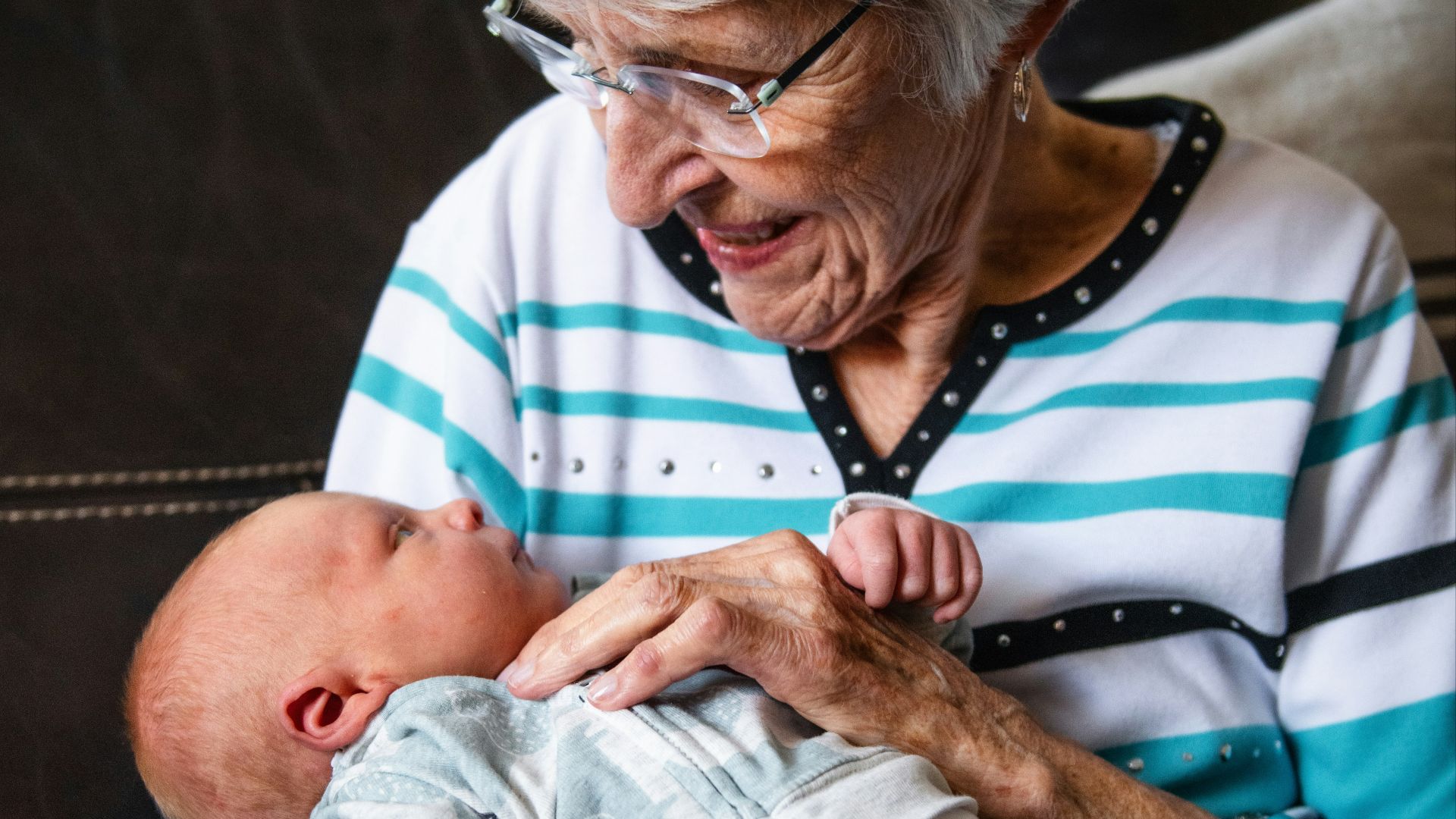 an older woman holding a baby