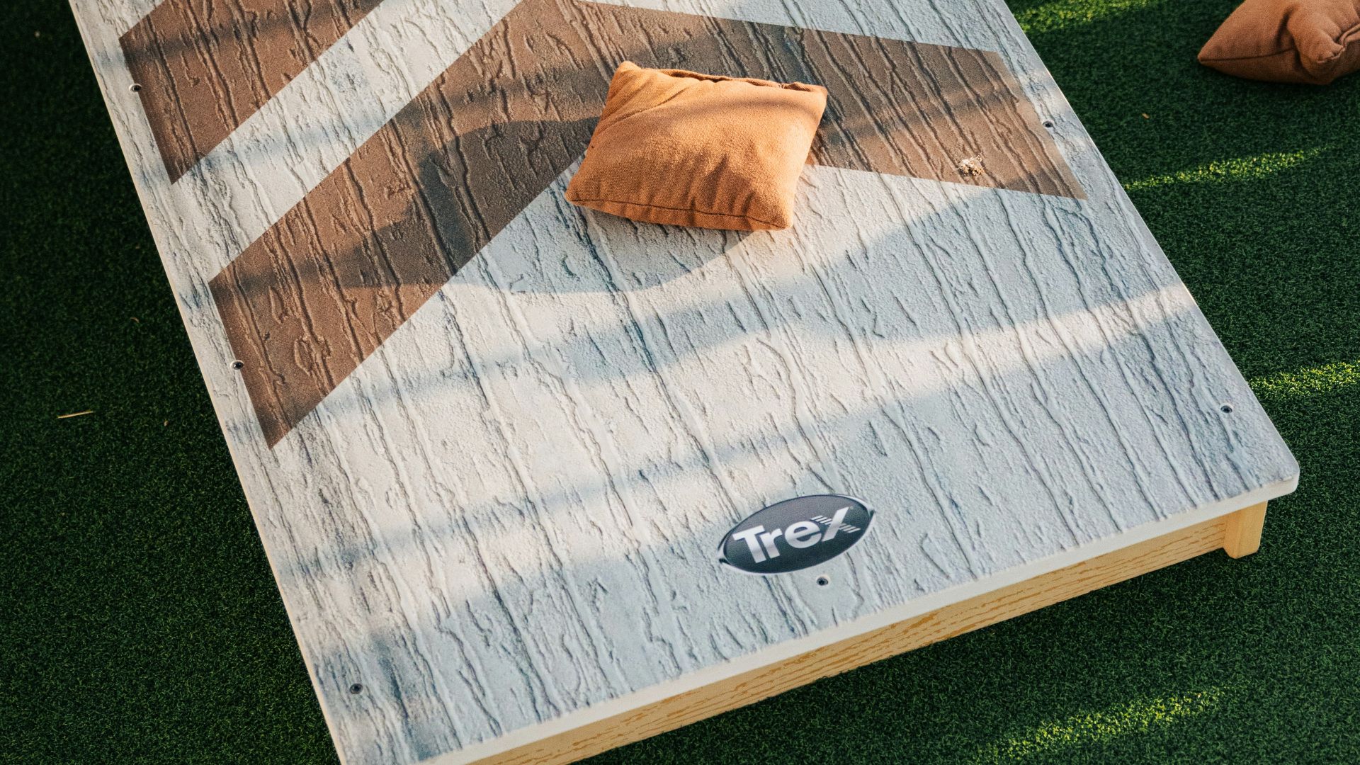 Cornhole boards and bags on green turf