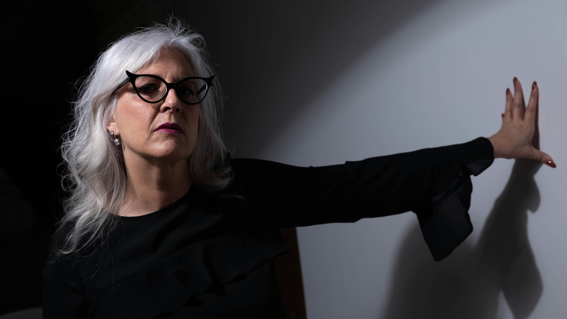 woman in black long sleeve shirt wearing eyeglasses