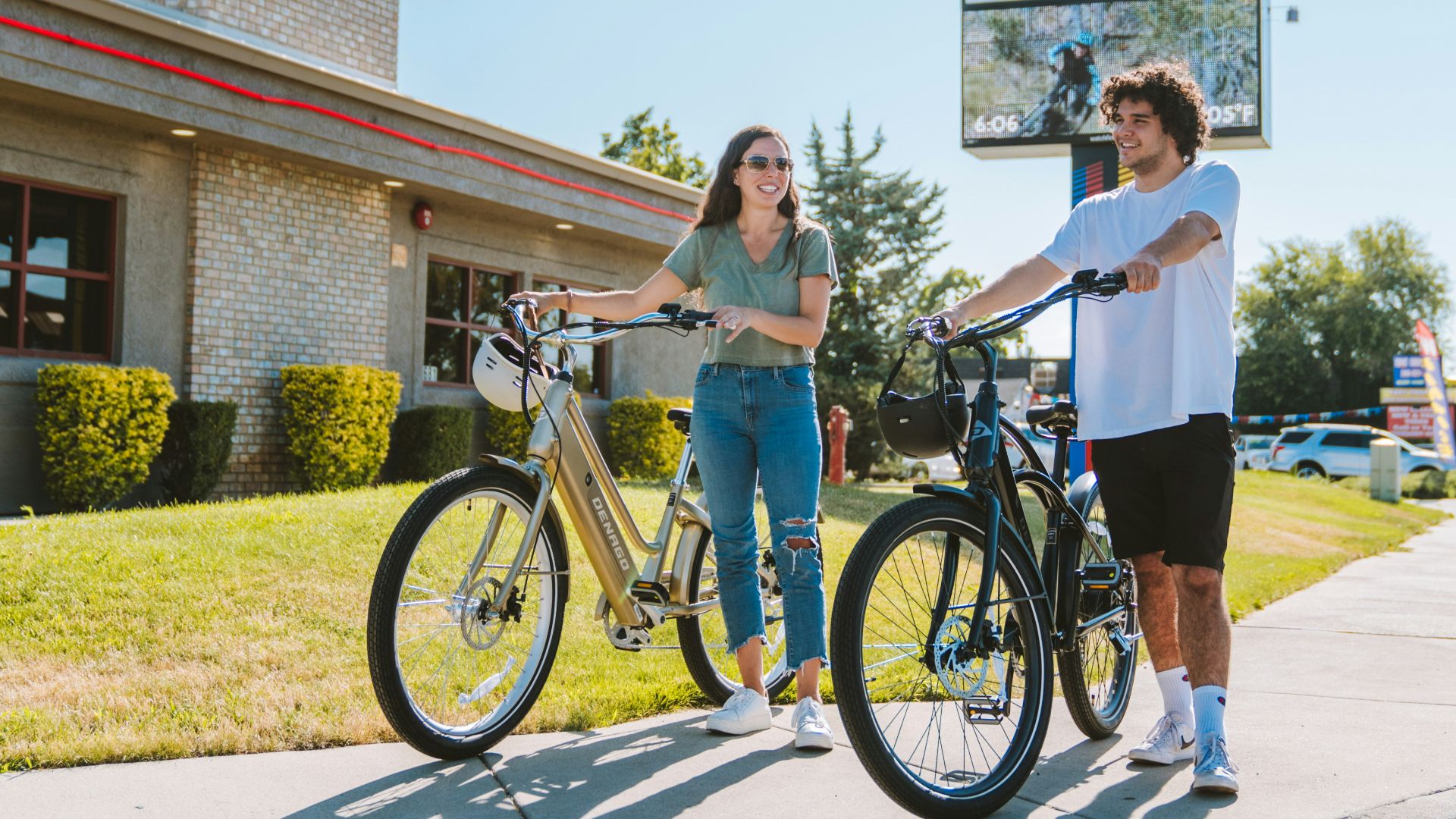 a man standing next to a woman on a bike