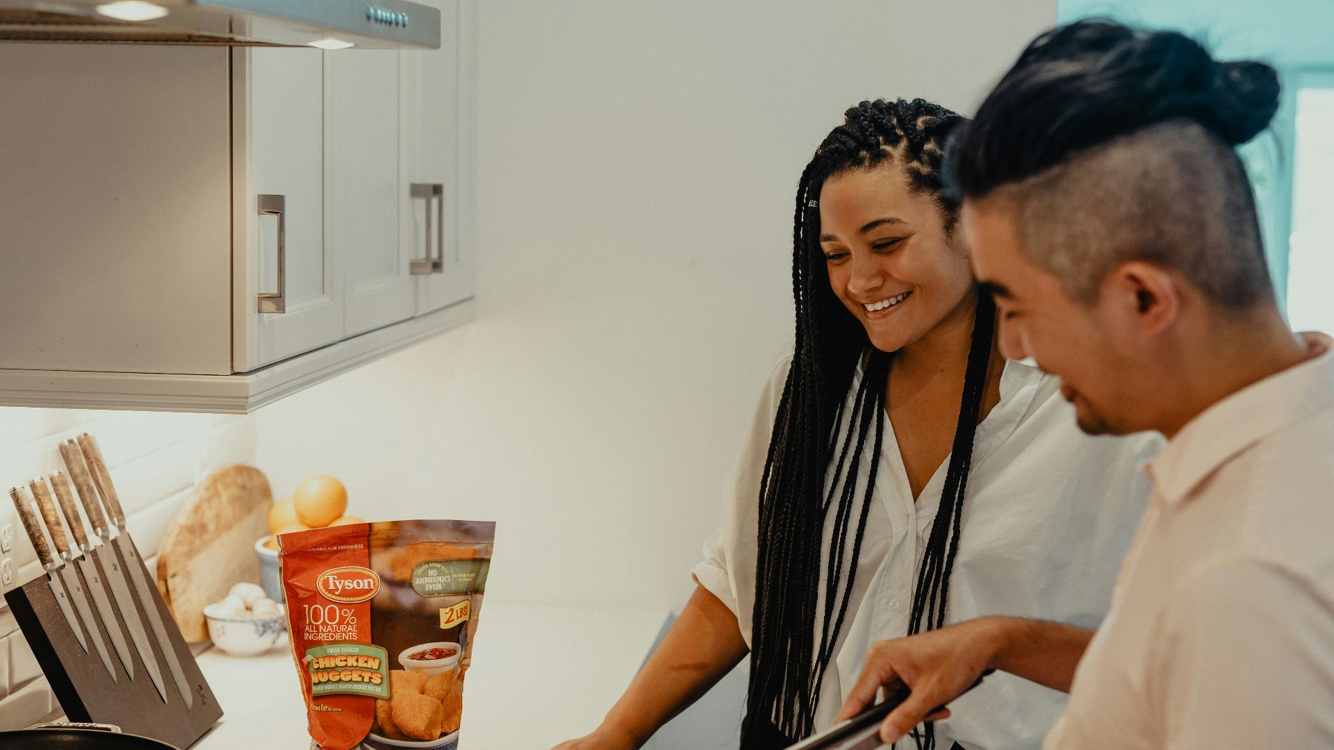 woman in white shirt holding black chopsticks