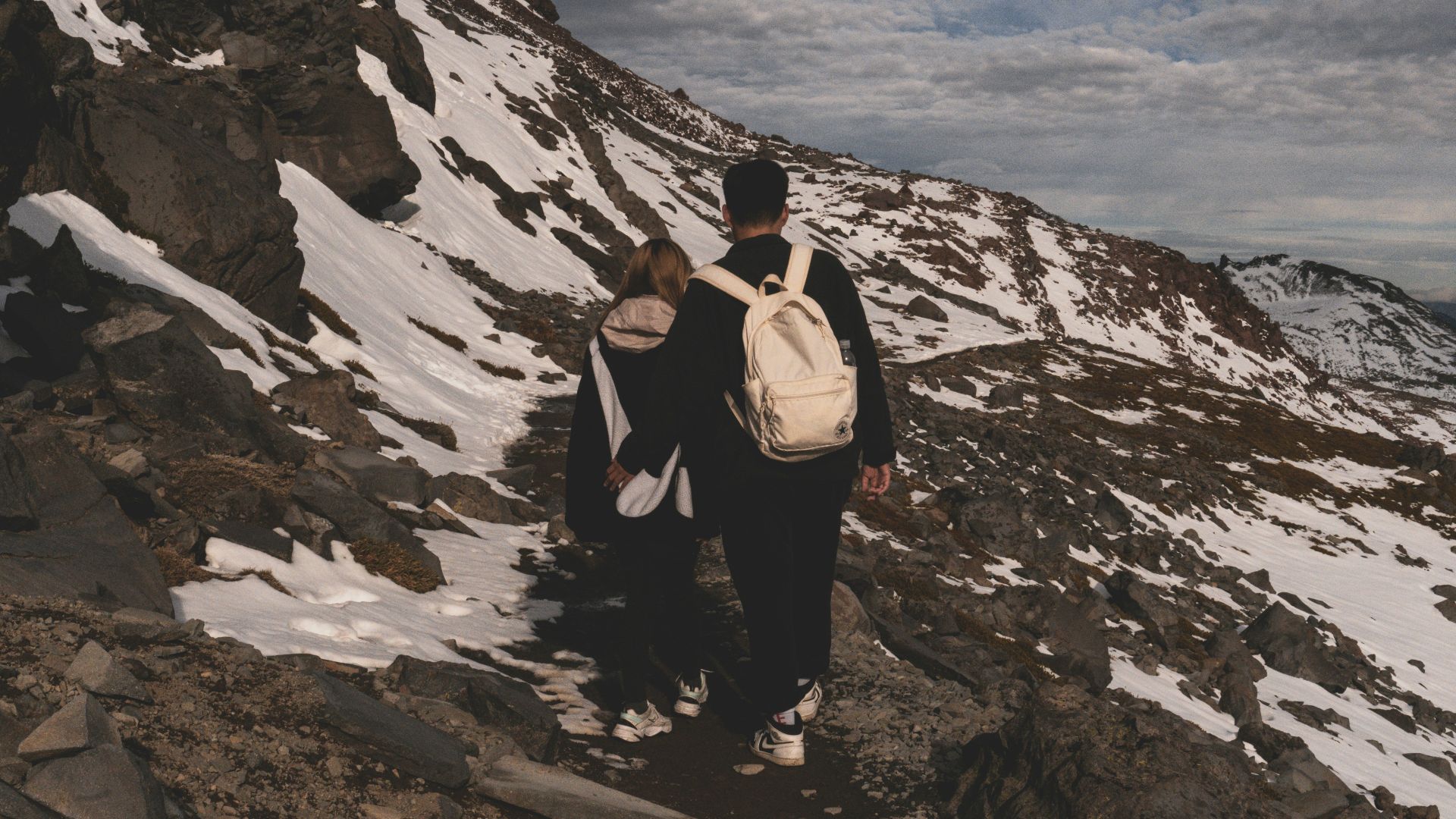 a couple of people that are standing on a mountain