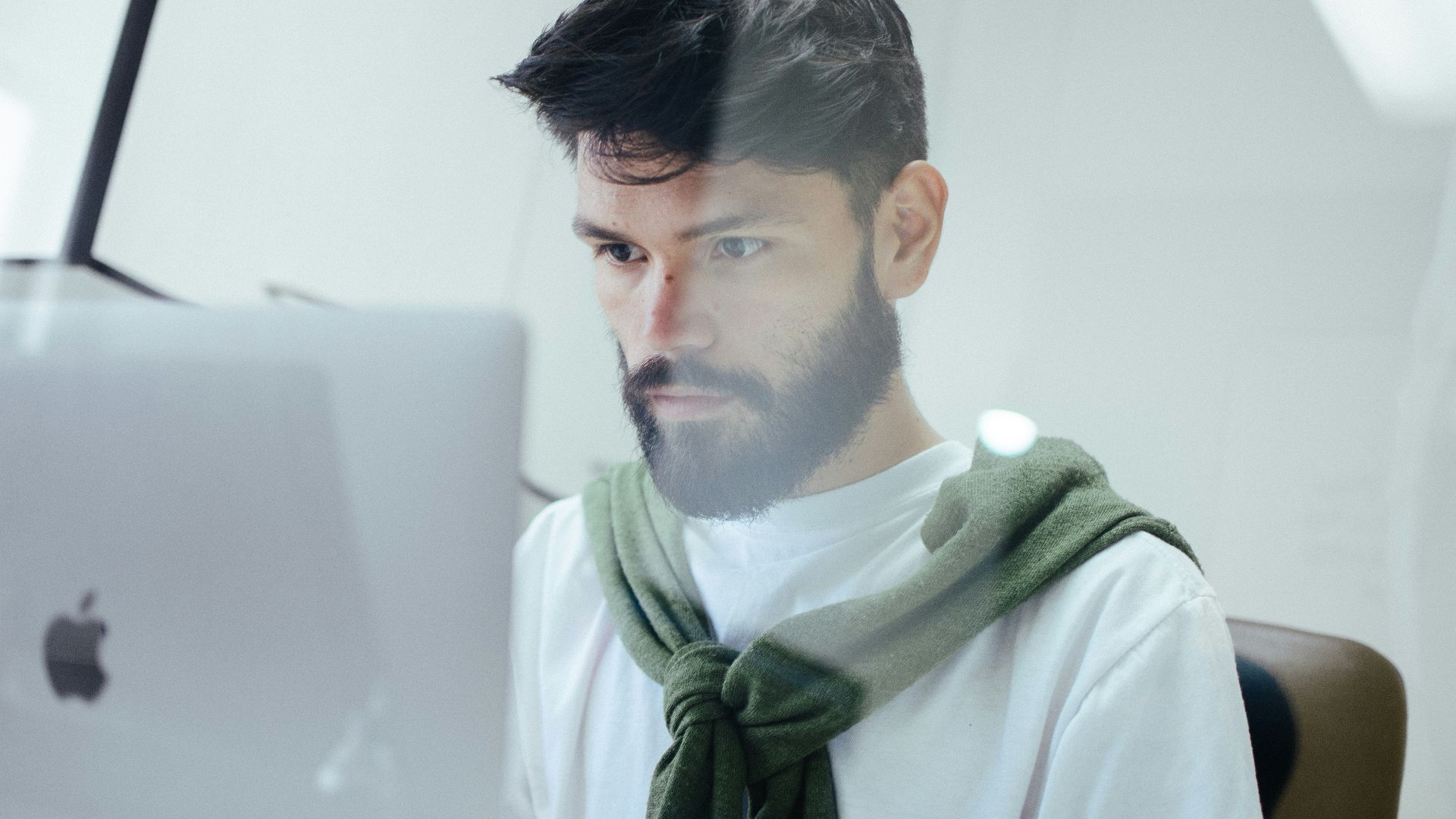 man facing MacBook Pro