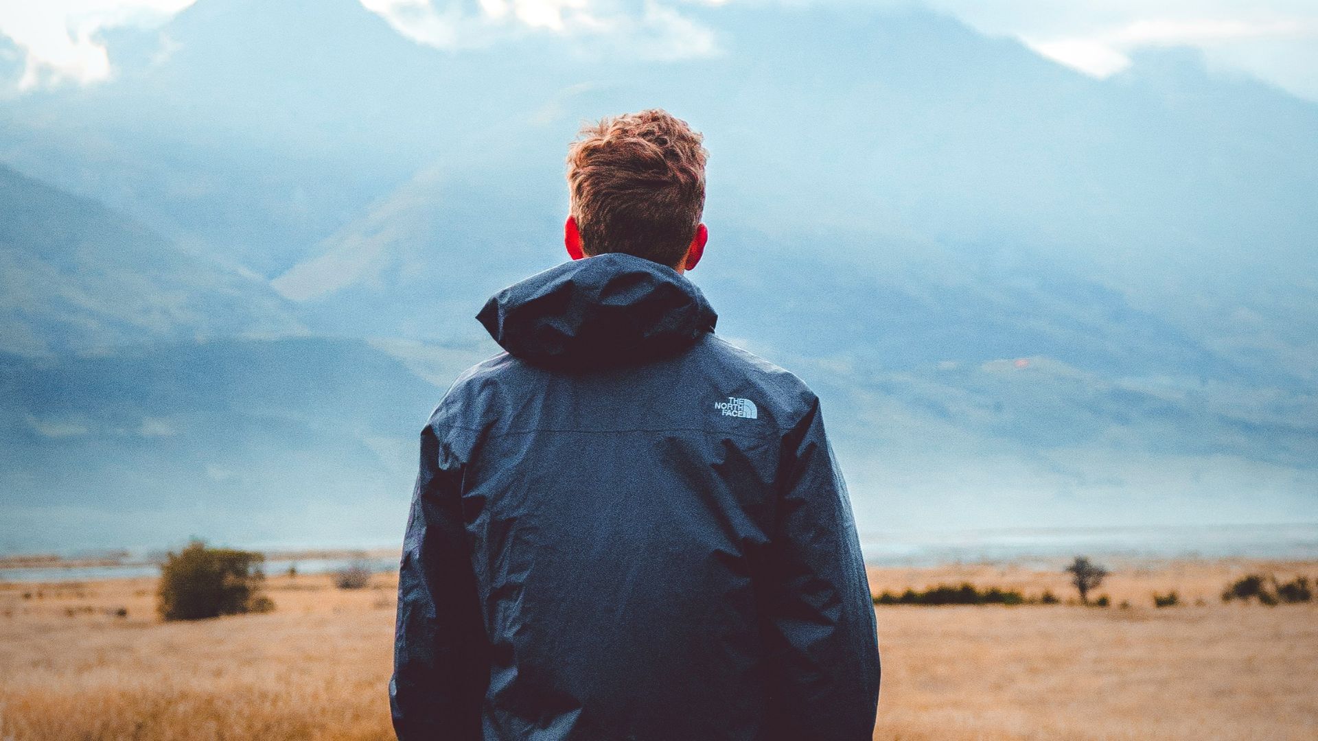 man in middle of wheat field