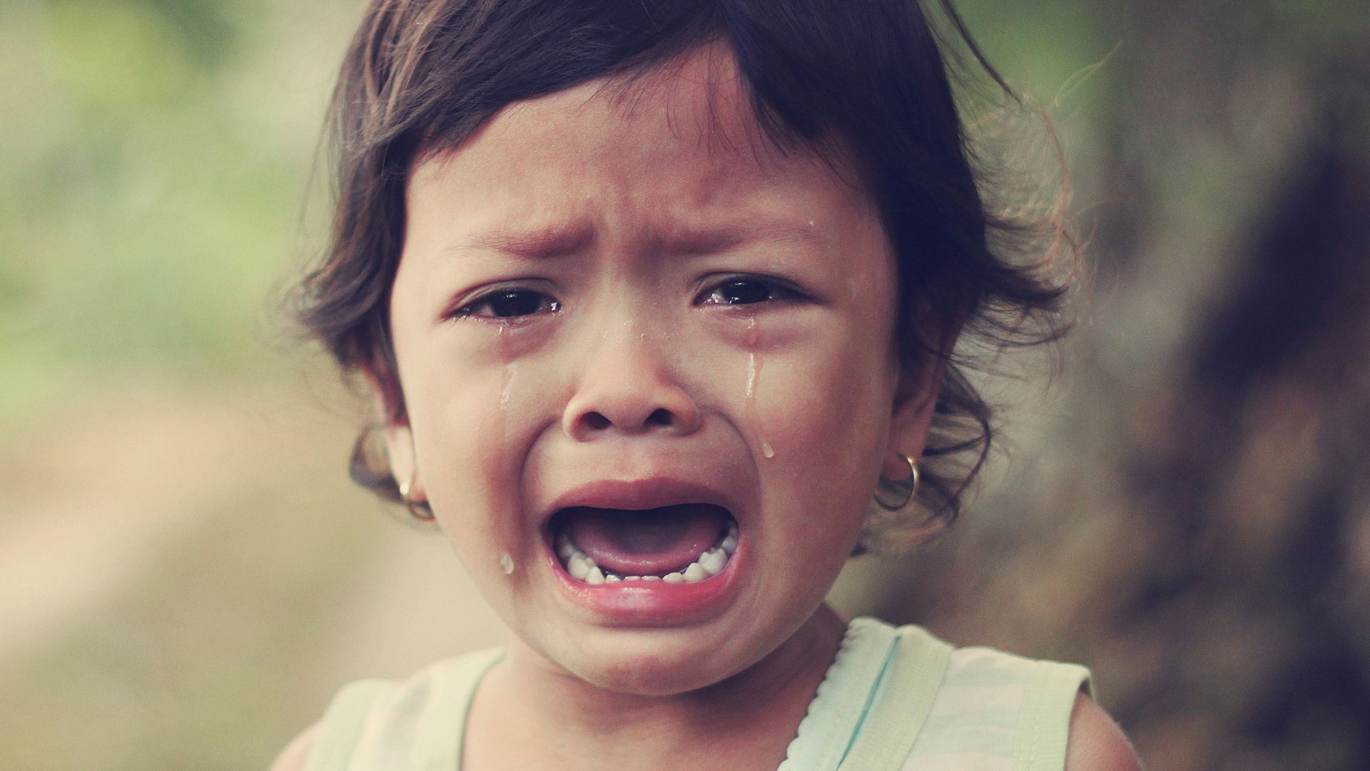 selective focus photography of girl crying