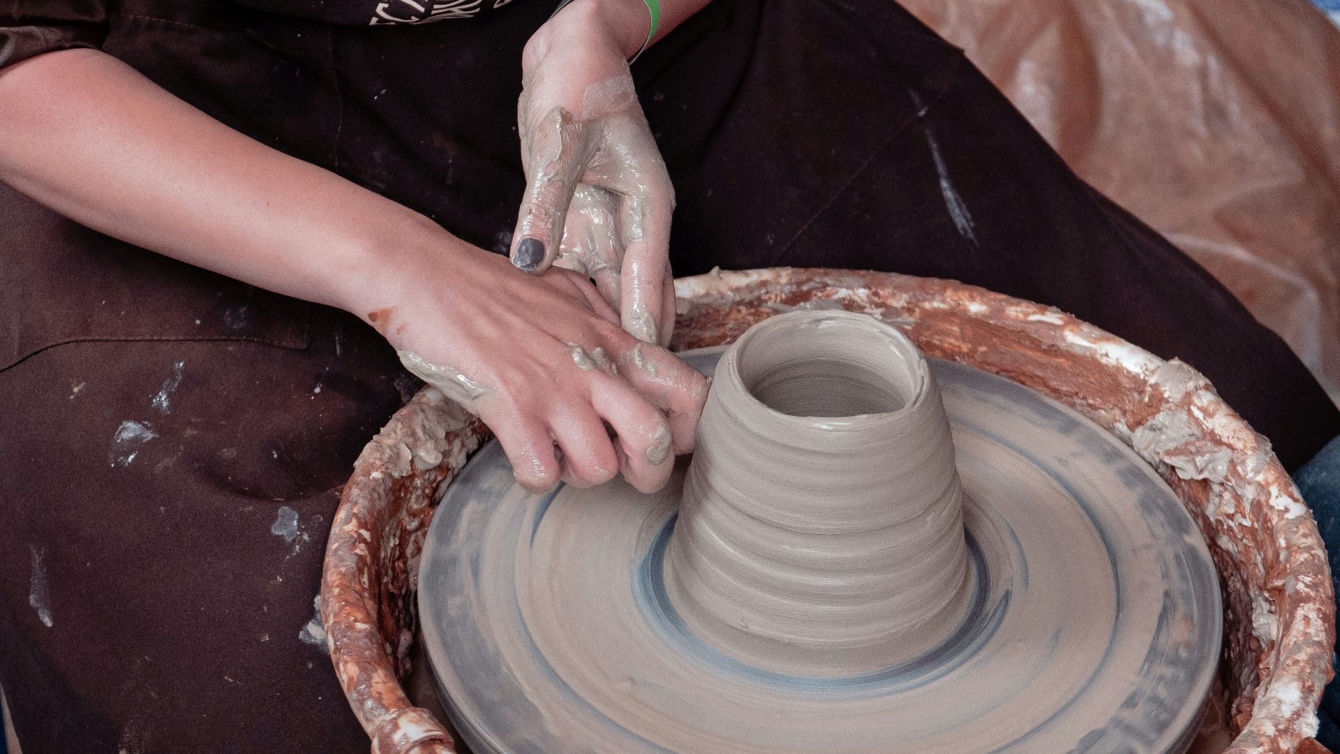 woman in black and white shirt holding white ceramic round plate