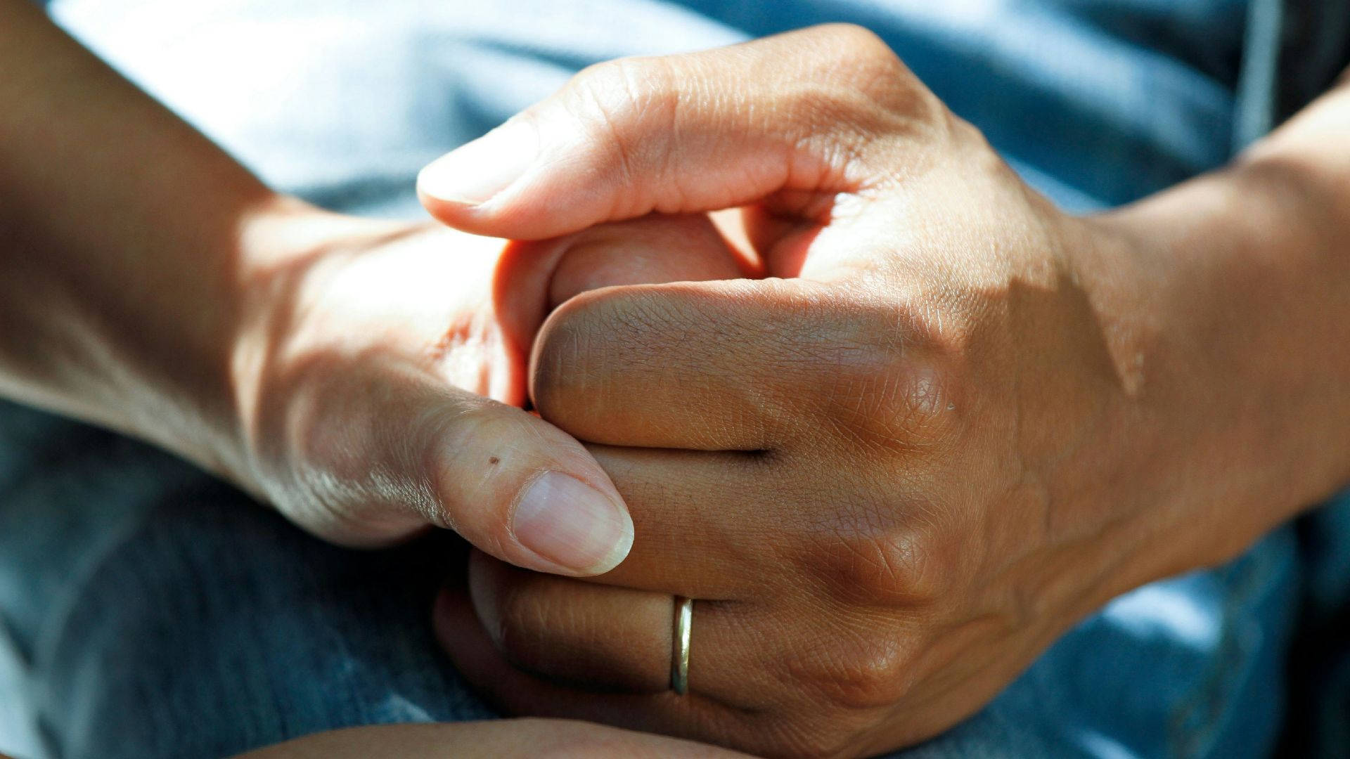 person wearing gold wedding band